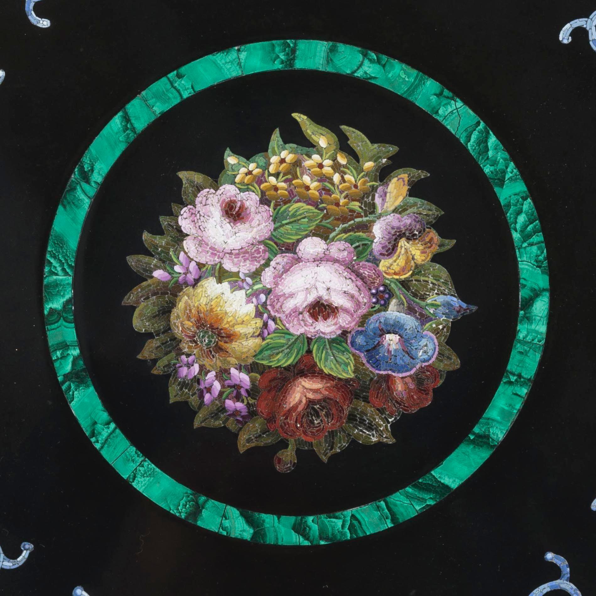 A grand tour circular table top
Possibly by Domenico Moglia

The circular platform of marmore nero, inset with fine micromosaic panels consisting of hundreds of coloured glass tesserae; a central flower bouquet sit within a malachite border