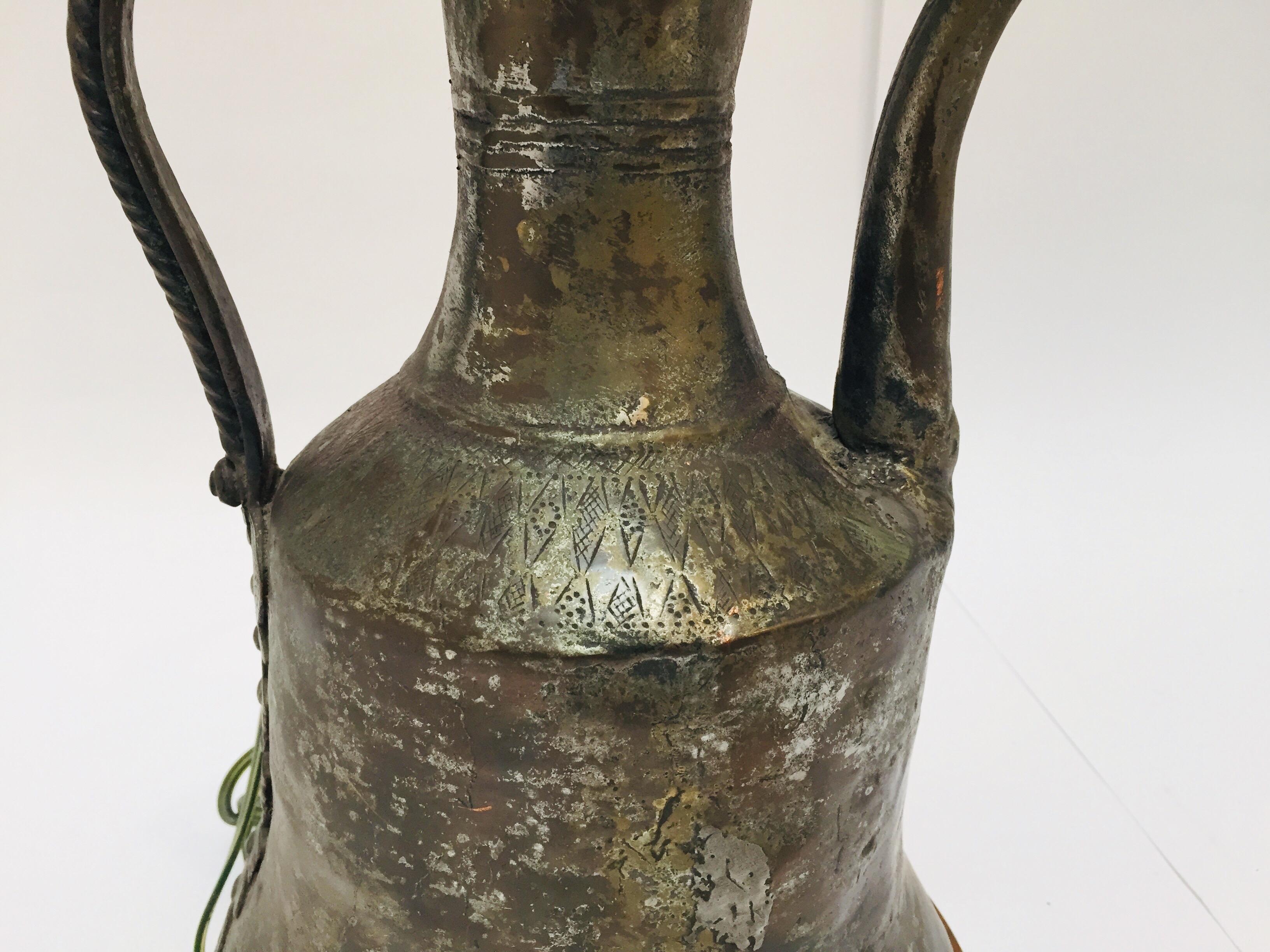 19th century Middle Eastern traditional Arabian tinned copper Dallah coffee pot made into a table lamp.
Coffee pot hand-hammered tinned copper with riveted brass finish.
Total height: 20