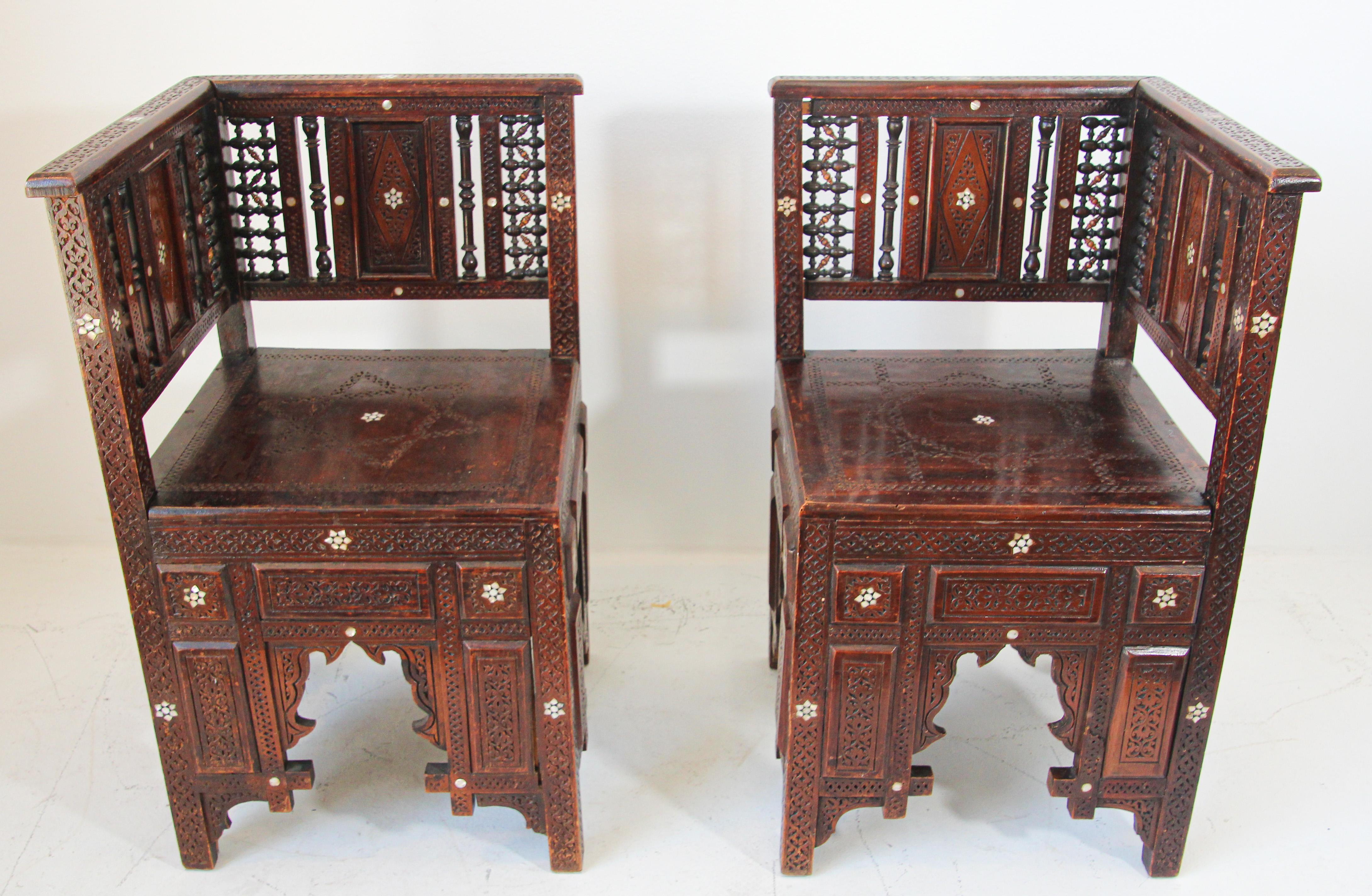 Antique late 19th century Middle Eastern Egyptian Moorish side chairs finely hand carved with intricate wood fretwork and inlaid with shell and bone.
Nice moucharabie fretwork designs on back chair,
Traditional Egyptian corner chairs with Moorish