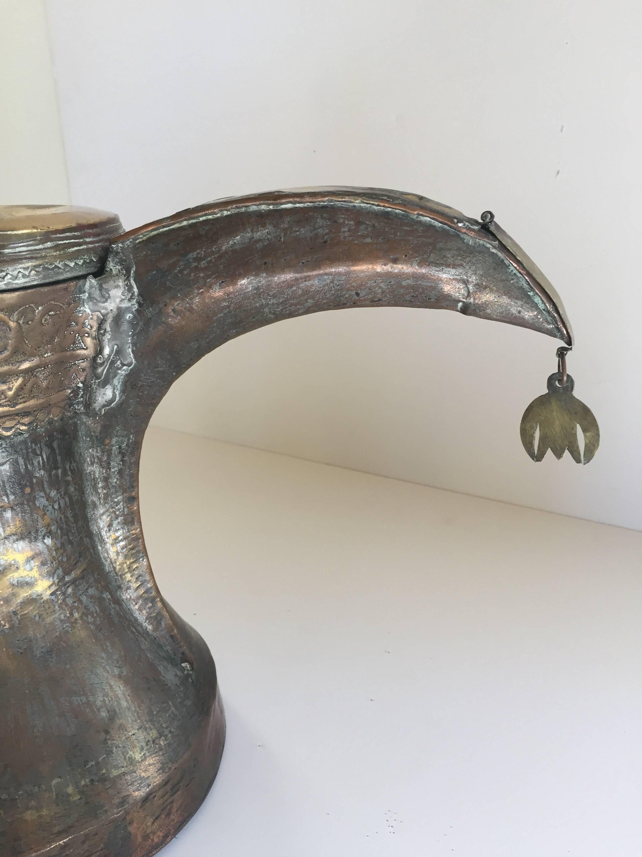 19th century Middle Eastern Arabian oversized tinned copper Dallah coffee pot.
Huge oversized antique Dallah brass coffee pot hand-hammered and chased copper with riveted finish.
This Middle Eastern Dallah Arabic Bedouin coffee pot body is made of