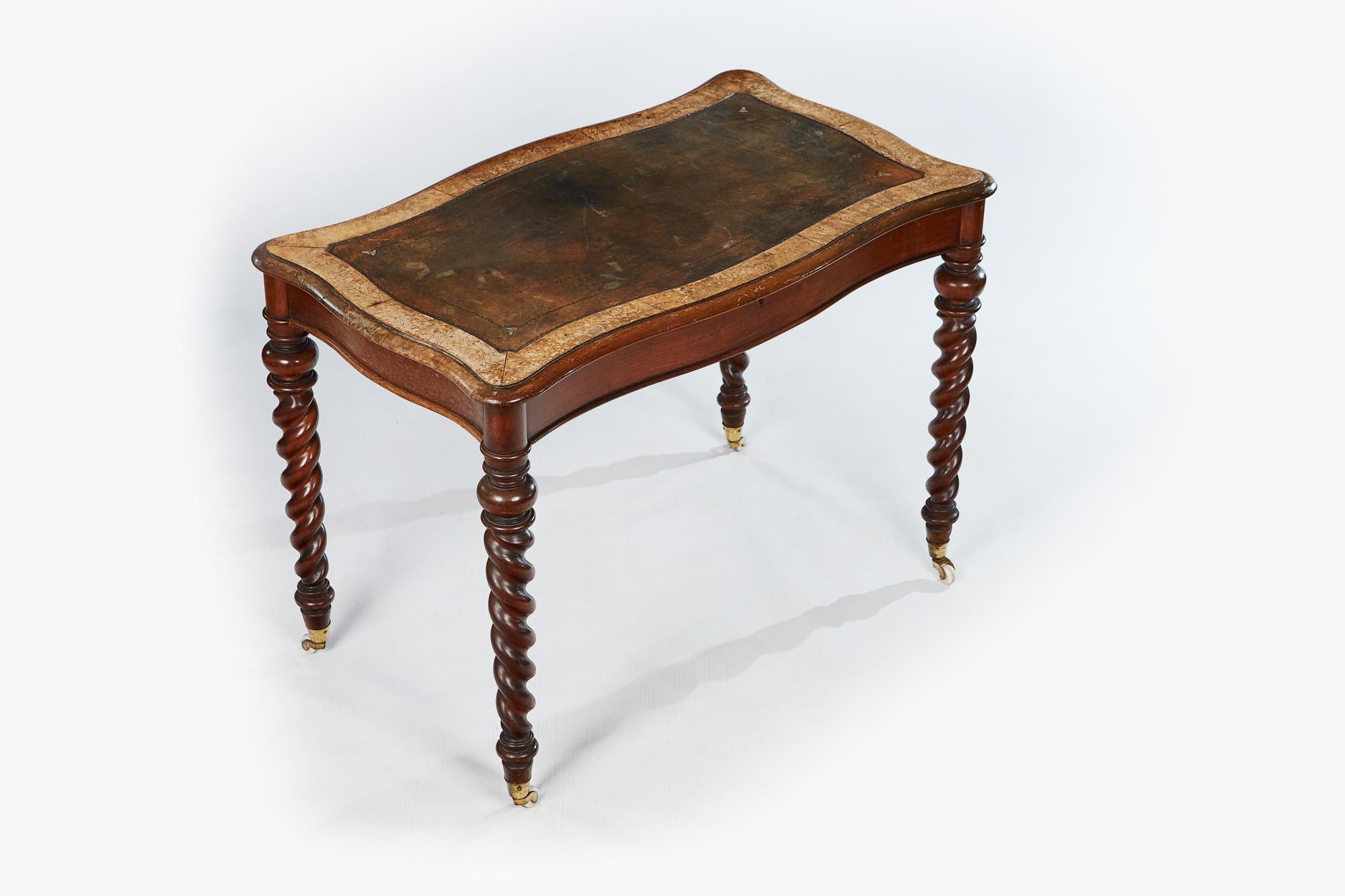 19th century Miles and Edwards writing table of unusual shaped top, with leather scribe on barley twist leg.