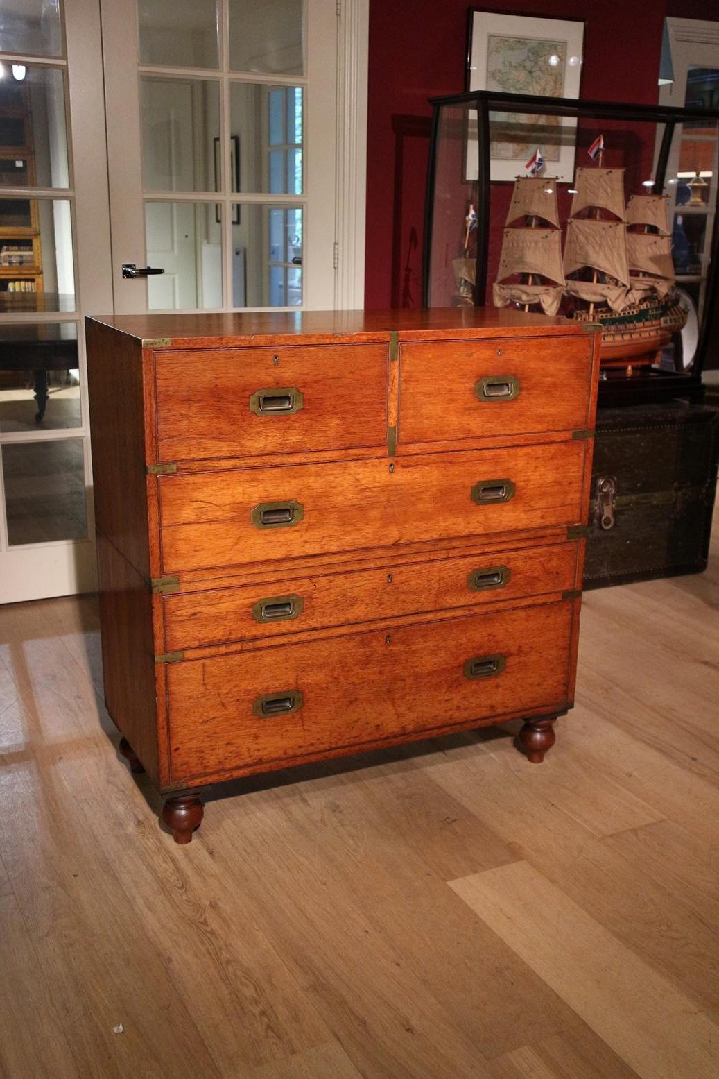 Beautiful antique teak campaign chest of drawers with secretary. The chest of drawers is completely in original condition and constructively perfect. It has the original look with signs of wear and the 1st polish finish is still present. The result