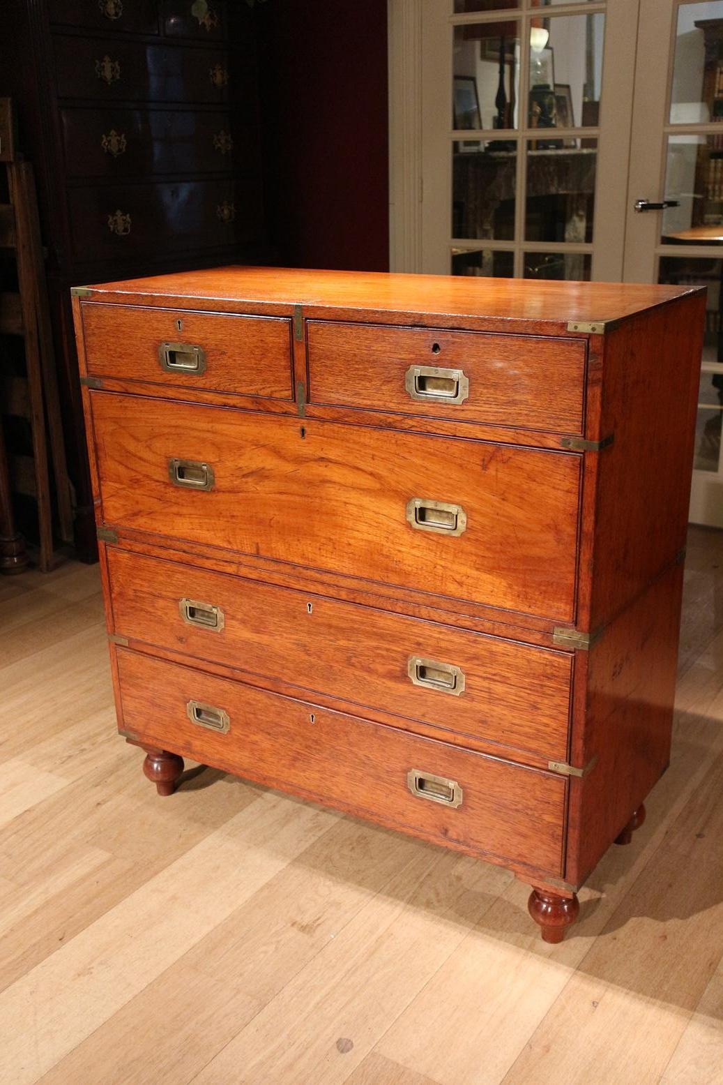Beautiful antique campaign / military chest of drawers consisting of 2 parts. The cabinet is entirely in original condition with original removable legs. The chest of drawers has the perfect look. Warm (original finish) color and signs of use. With