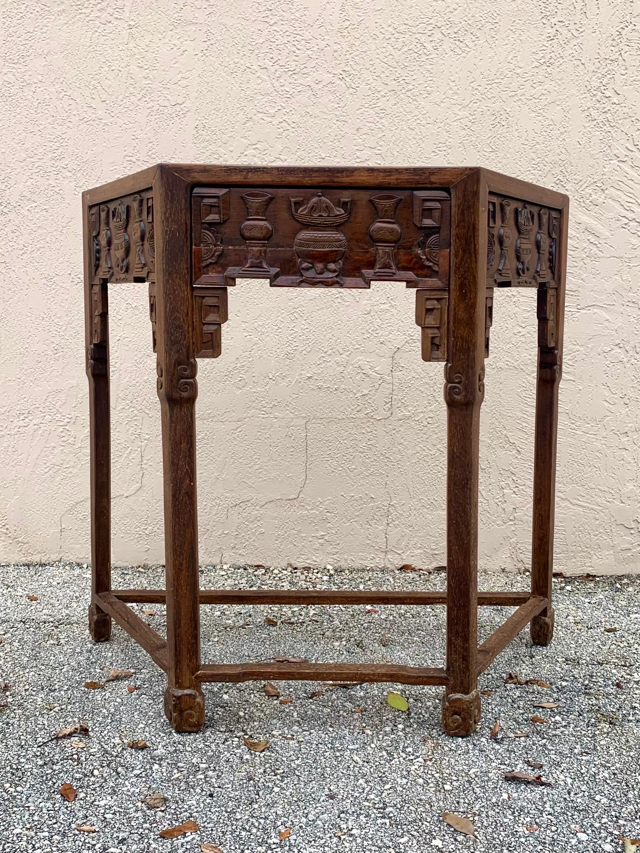 Beautiful hand carved Chinese console table. 19th century or potentially earlier. Qing dynasty or Ming dynasty style. Likely haunghuali wood. Trapezoid table top with inset marble. Strong heavy wood beautifully and masterfully hand carved with vases