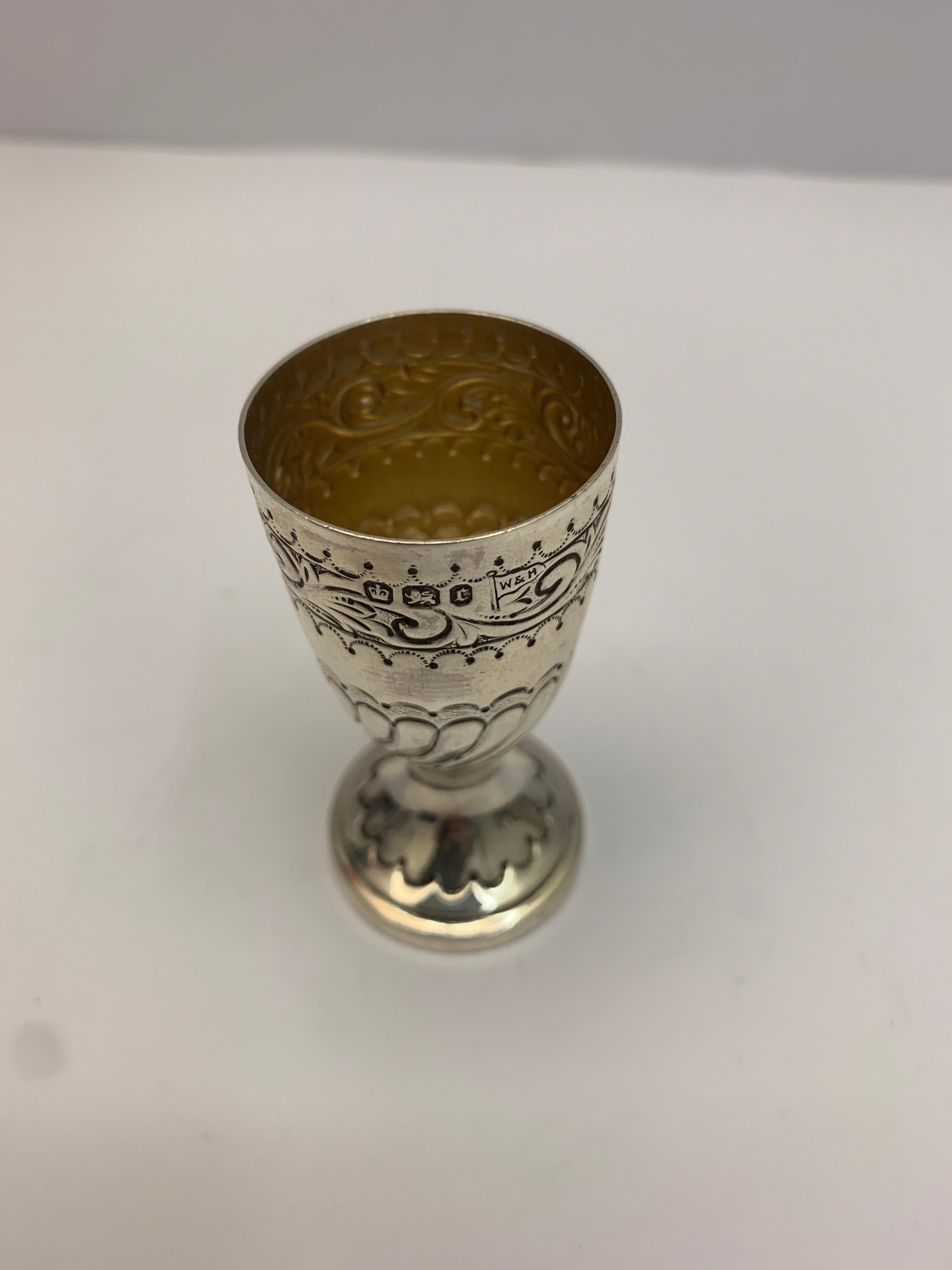 A mini silver chalice made in 1895. Delicately decorated with a gilt interior.
