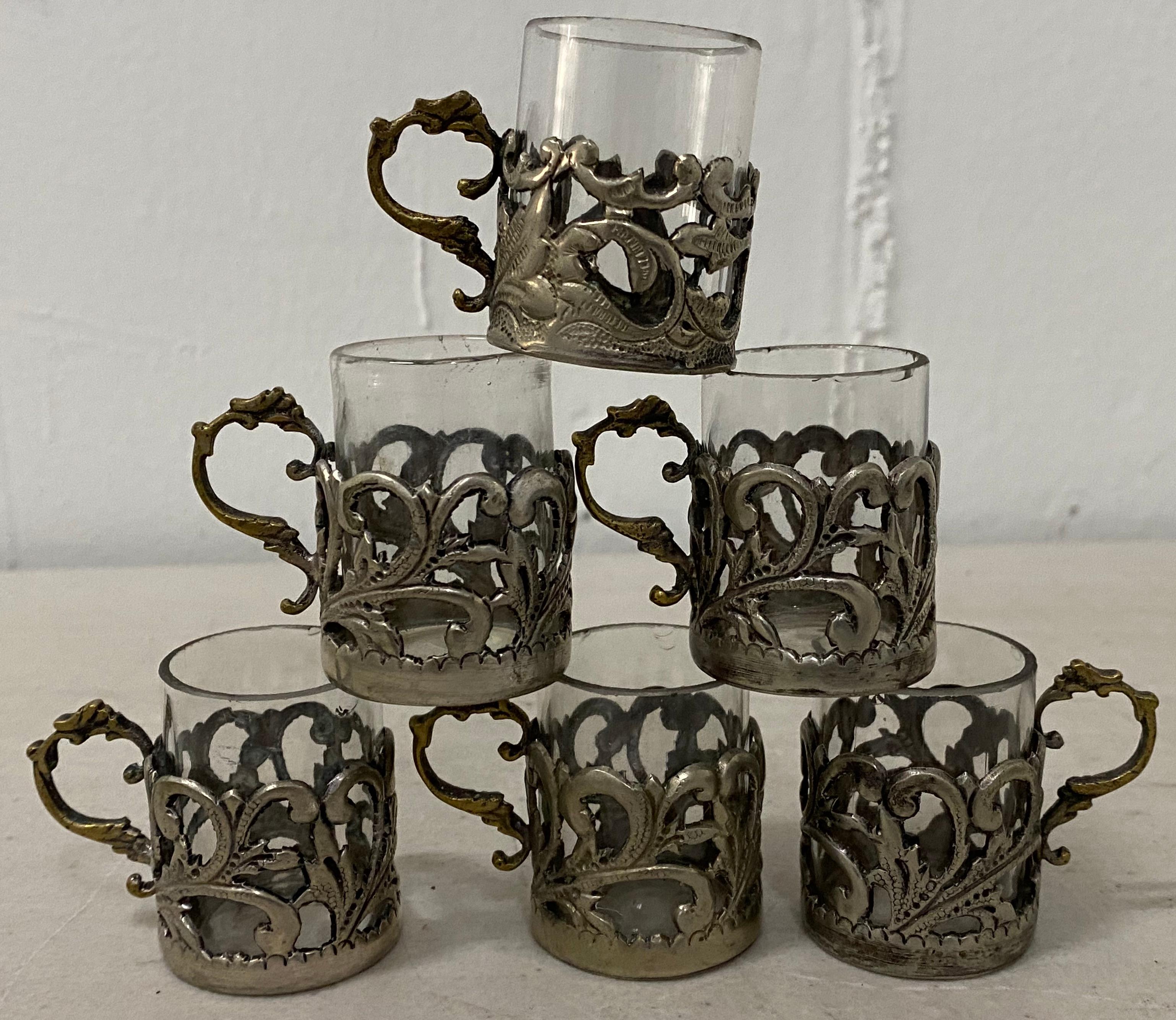 19th century miniature sterling silver liquor cup holders with glass inserts

Set of twelve

Six with glass inserts

Miniature dessert liquor cup holders

Handmade

A few have indecipherable hallmarks (see images)

Measures: 1.25