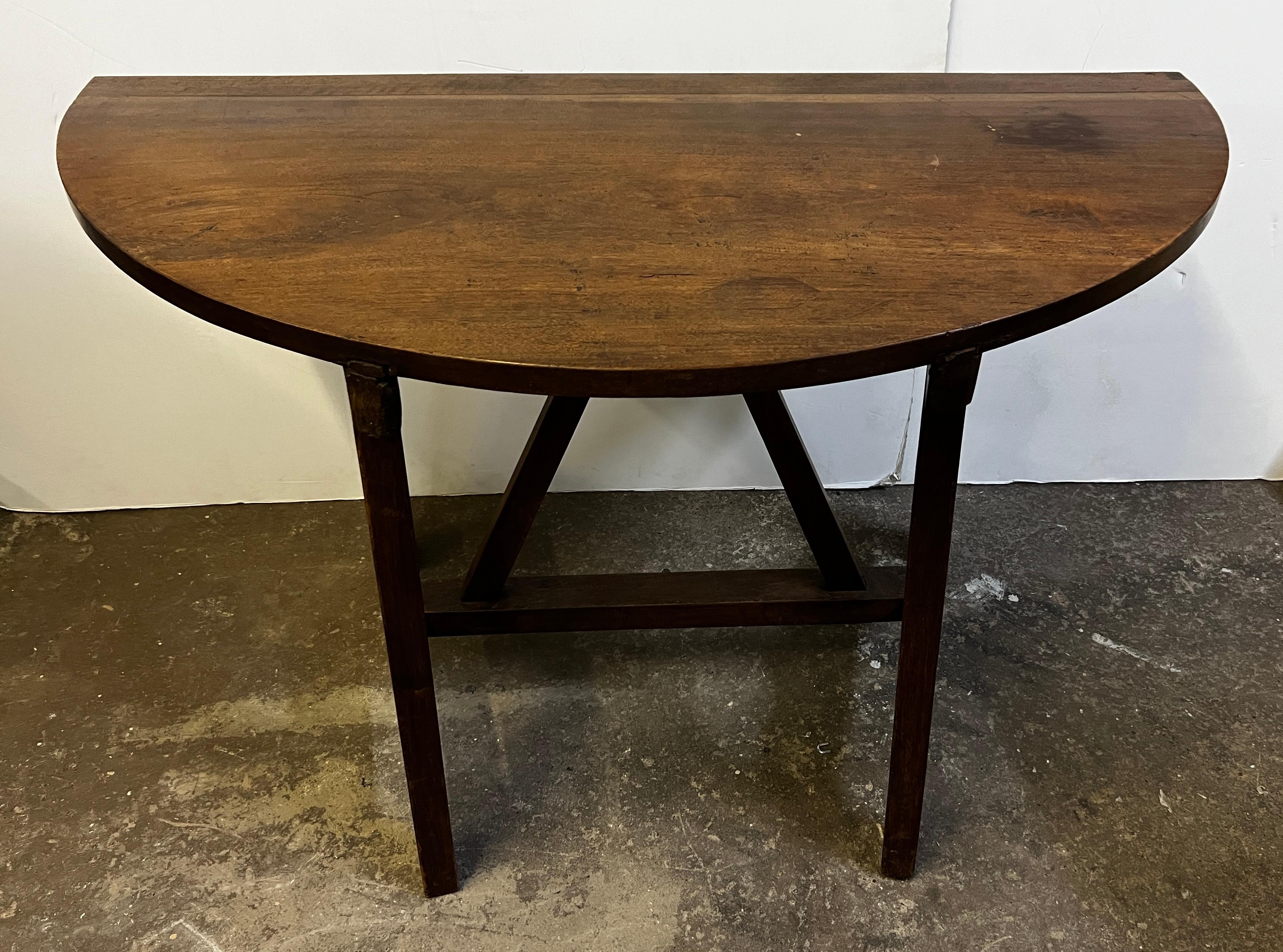 A minimalist look at it's best with this 19th century pair of Italian demilune tables. These are perfect to flank a fireplace, bed, or use in hallway. Unique and simple is what you are receiving with these two. They are not identical due to being