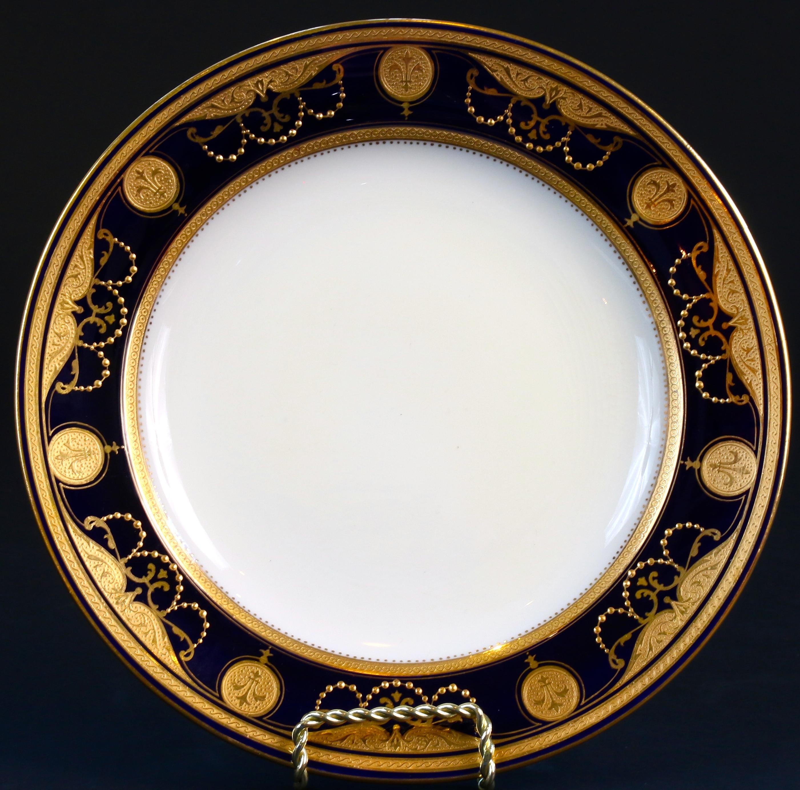 This 19th century Minton, stoke-on-trent, England, cobalt dinner service is both extraordinary and rare. The design features a 22-karat acid-etched gold inner and outer border with 22-karat gold encrusted medallions, swags and gold beading. The set