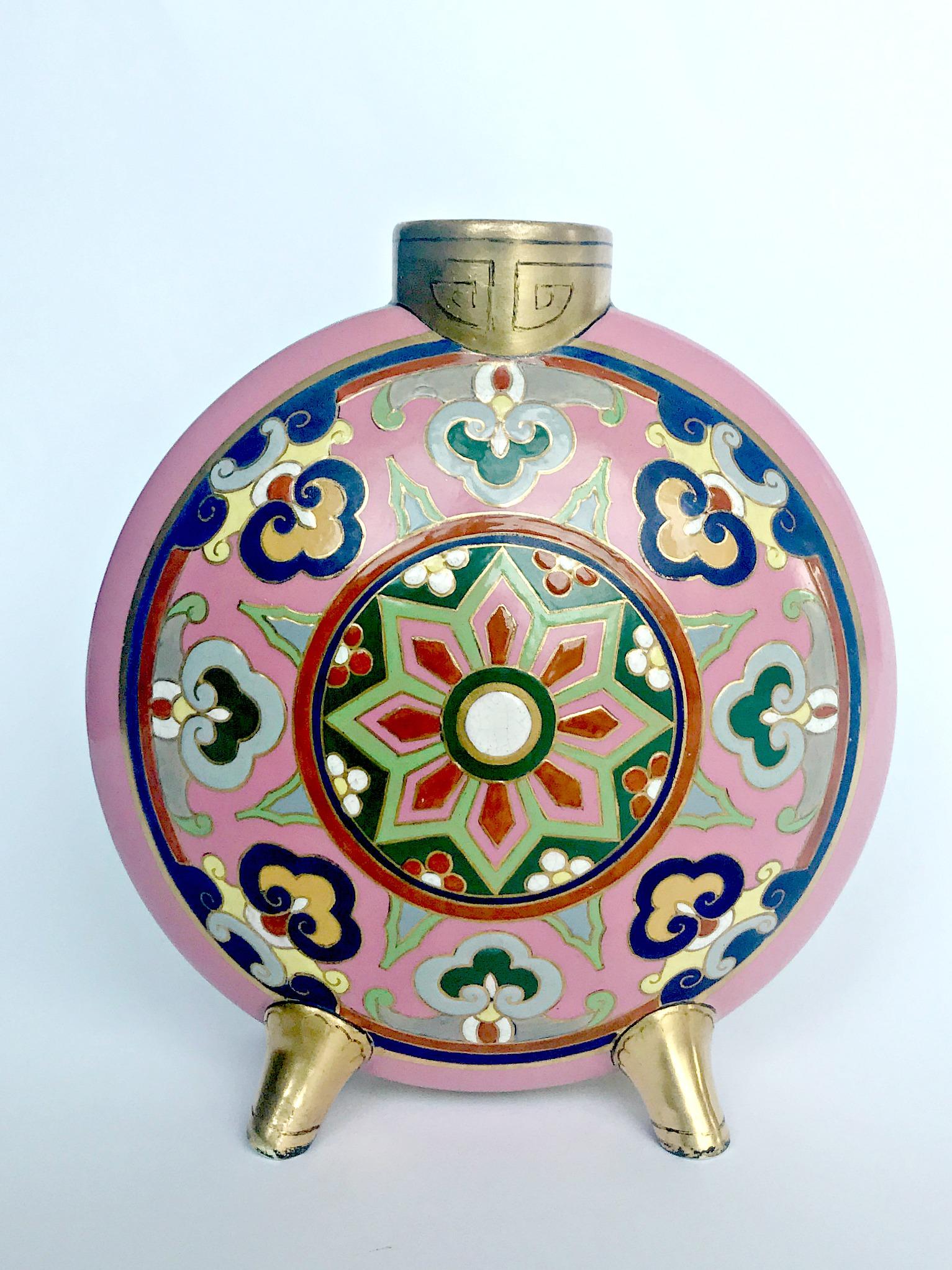 A rare Minton porcelain Aesthetic Movement porcelain vase designed by Christopher Dresser circa 1875 decorated in the 'cloisonné' with polychrome stylised enameled motif against a pink ground, the neck and legs decorated in 22ct gilding.

No