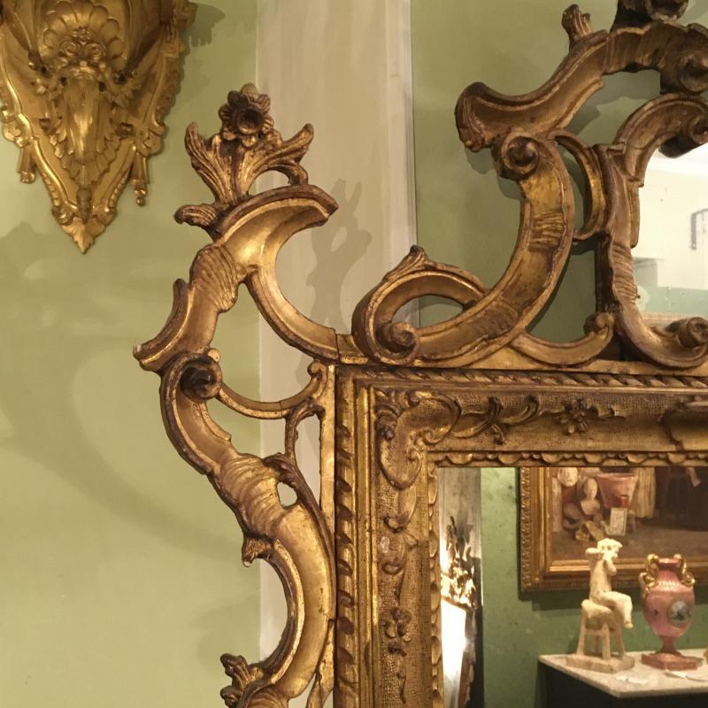 Beau miroir ancien de dimensions importantes du 19ème siècle caractérisé par un riche encadrement en bois finement sculpté et doré.
La beauté est dans le cadre grâce à ses formes particulières. 
En outre, un autre petit miroir se trouve dans la