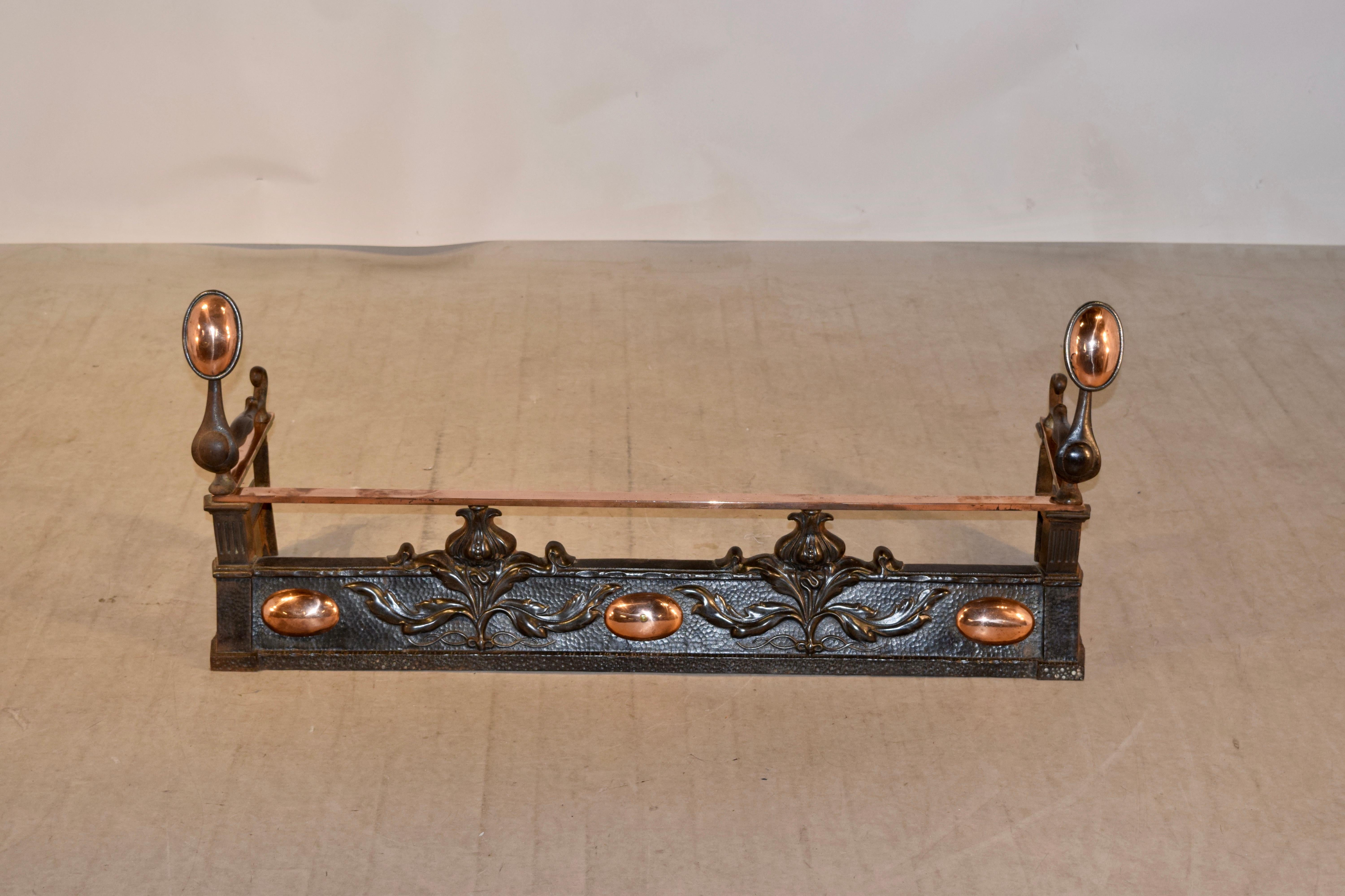 19th century fire fender from France made from iron and copper. The designs are Art Nouveau in style and are of lovely florals and are set off by brass medallions in between the florals. Makes a wonderful statement.