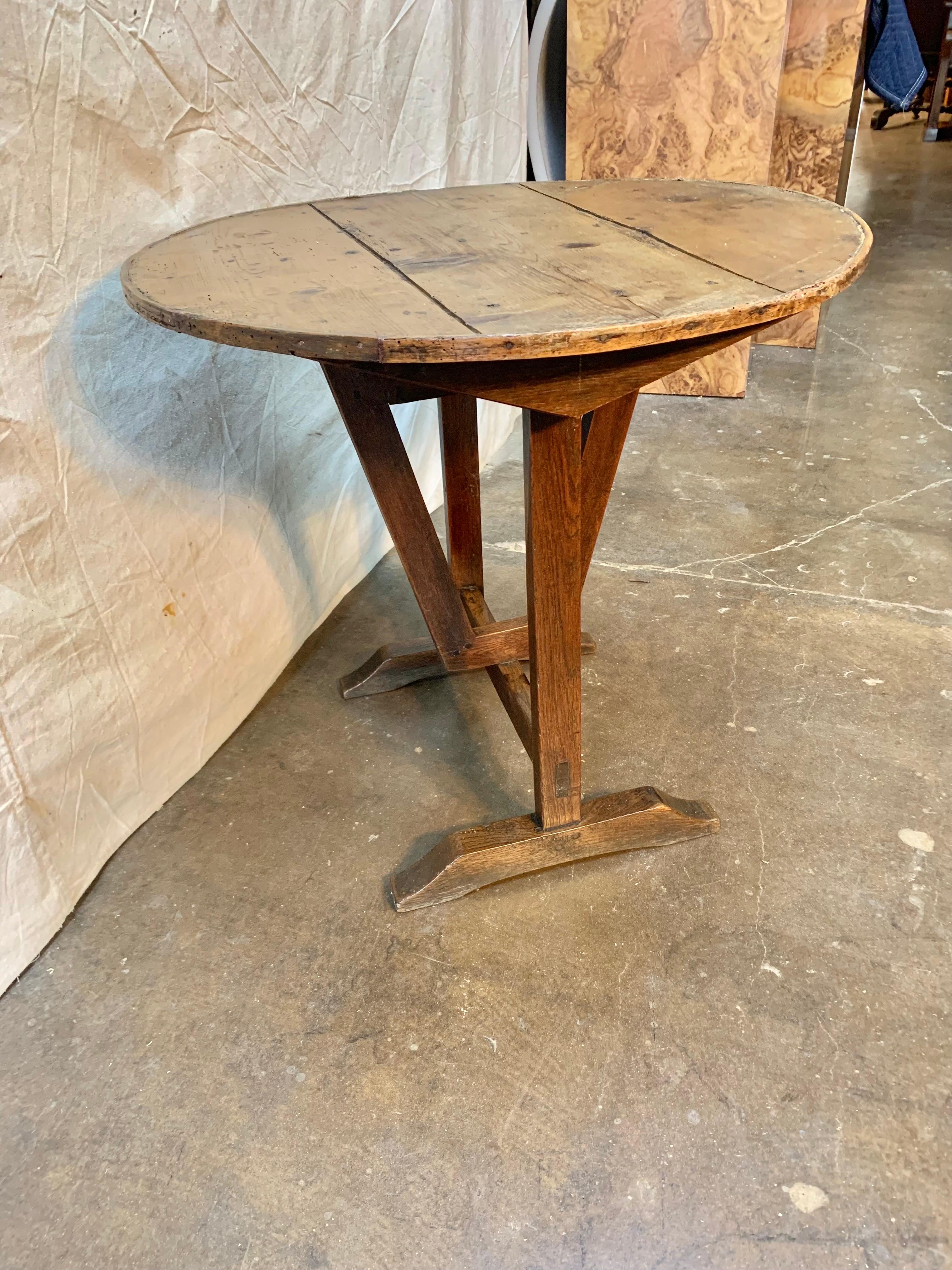 19th Century French wine tasting table, also known as a vendage or vigeron table, which was once used in the vineyards of France for tasting wine or enjoying a meal. This table would be suitable for use as a side table or in a wine cellar.  The top