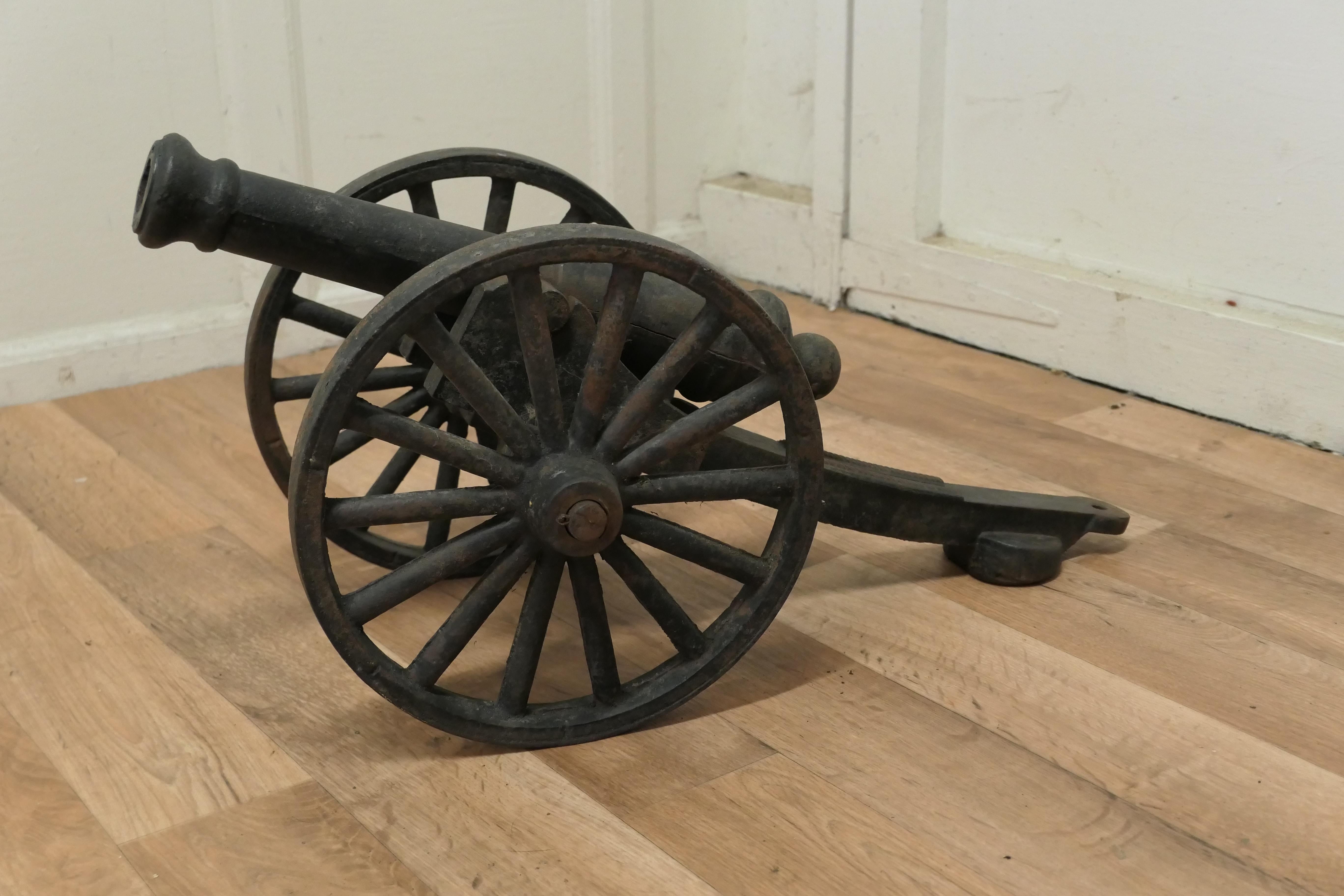 19th century Model Field gun on carriage, cast iron porch cannon
 
A good and well made piece, the field gun is made in good detail, this piece has spent most of its life outdoors, and has a well weathered patina, it has a firing split on the