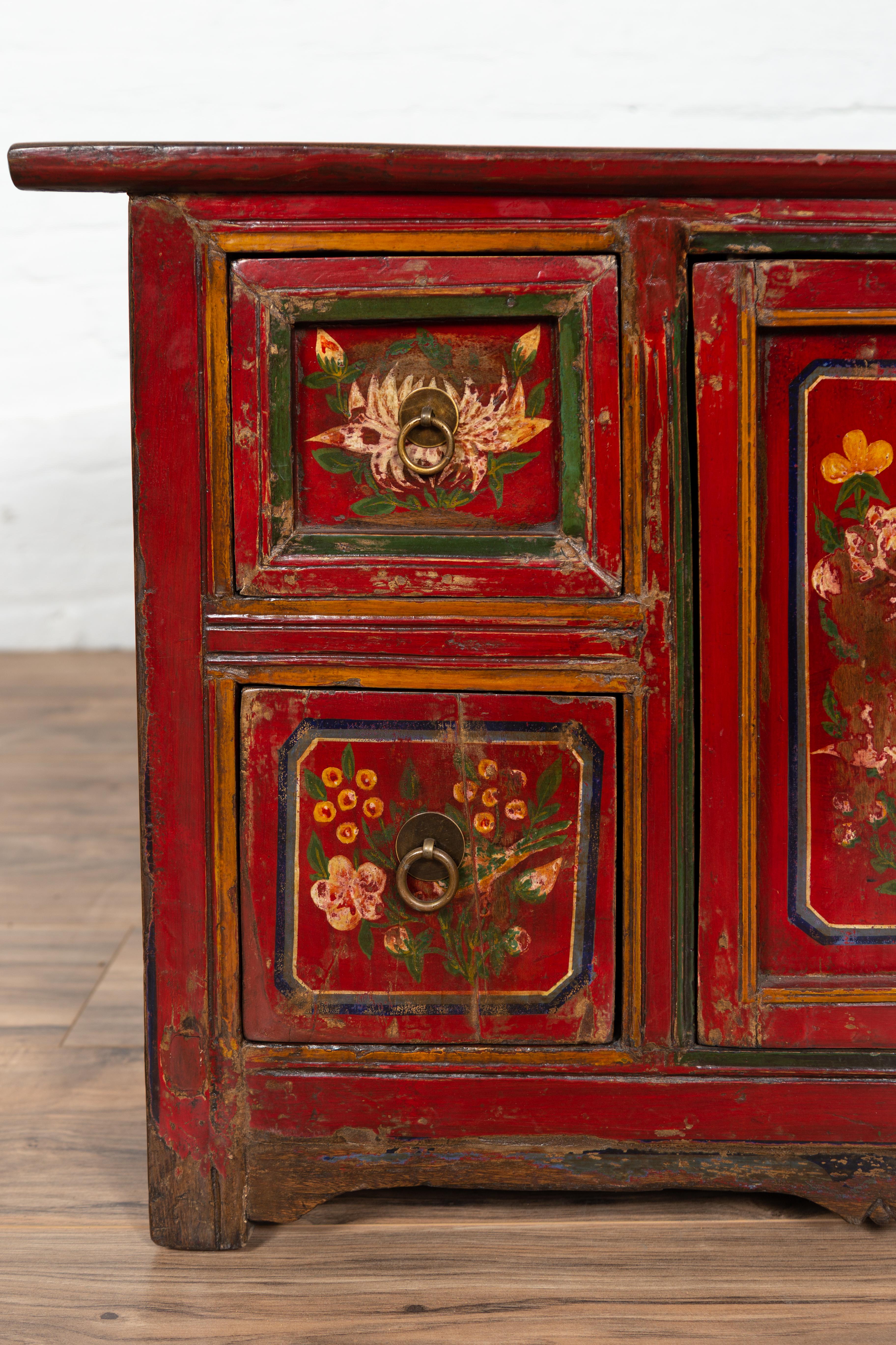 red floral painted wood cabinet