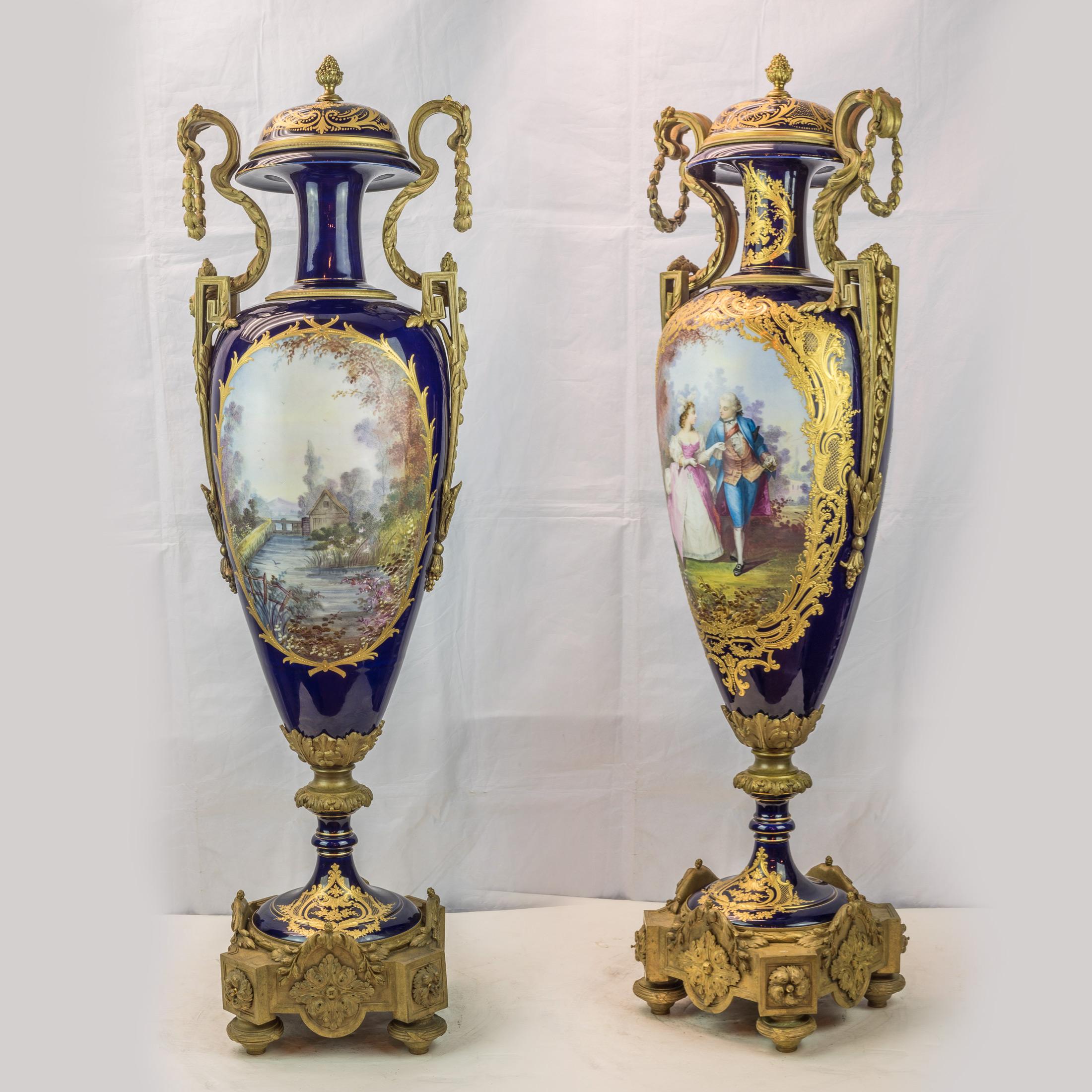 A fine and important monumental pair of Sevres gilt bronze mounted, hand painted with extensive gilt highlights, cobalt blue porcelain vases and cover with lovers and landscapes on octagonal base.

Date: circa 1880
Origin: French
Dimension: 41
