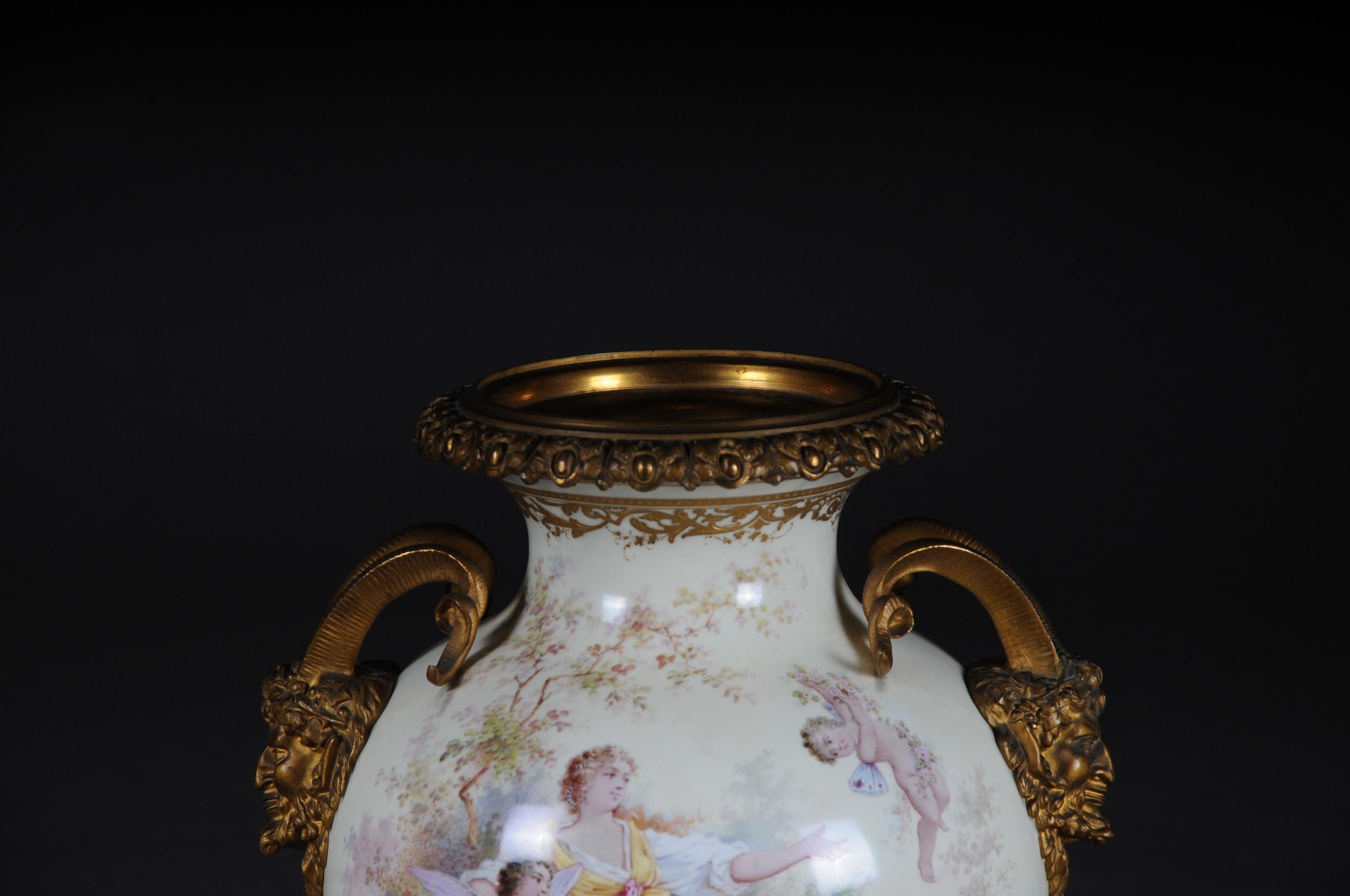 19th century monumental Sèvres pomp vase with bronze mounting

France, circa 1900
Eggshell colors glazed with delicate coloring: Venus and Amor Boy, accompanied by Cupids. Signed: G. Poitevin. Cupid with dove on the back. Relief gold friezes.