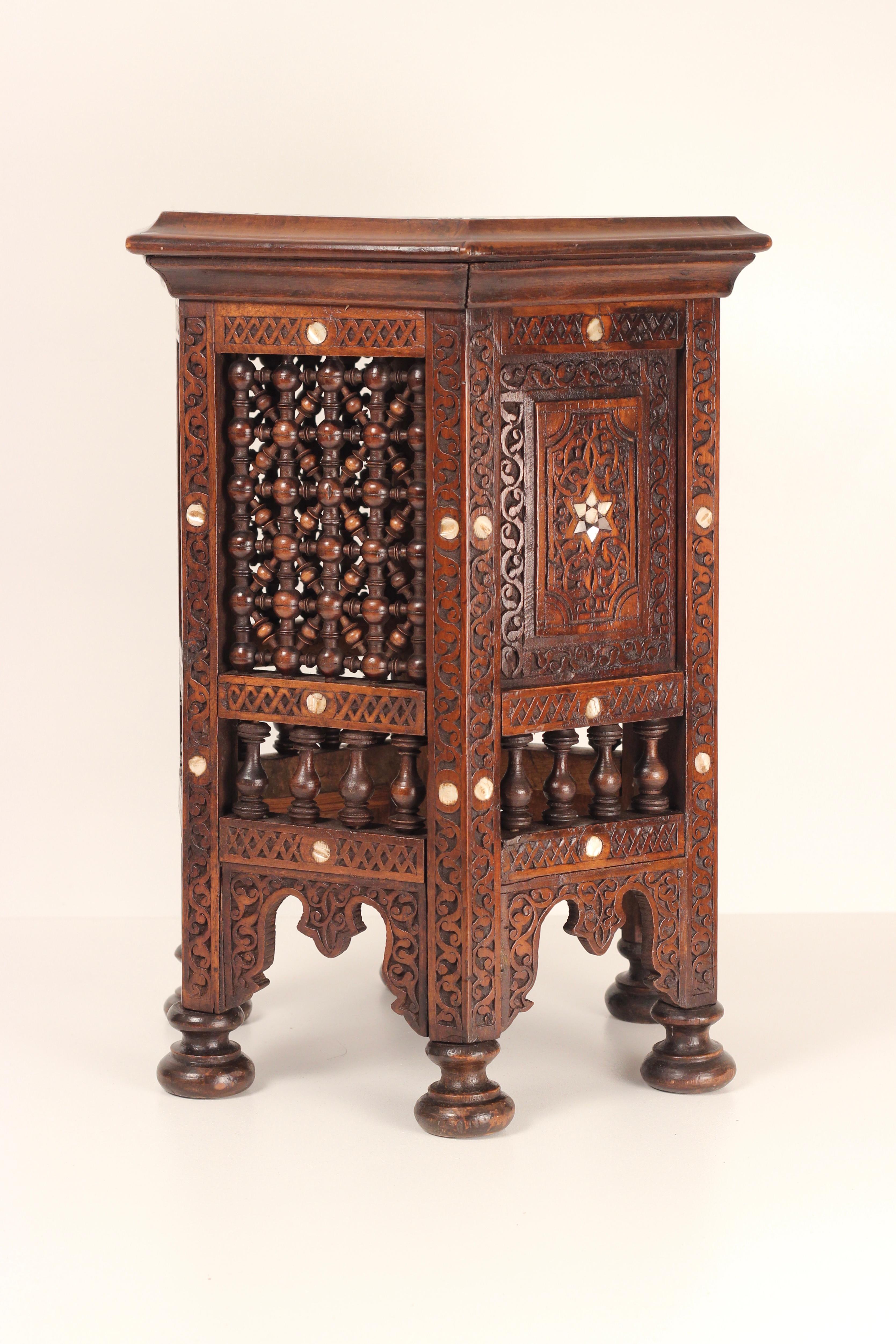 Antique Ottoman side table made around the end of the 19th century in Lebanon. An ornately carved geometric design with delicate Mother of Pear inlay flowers in the Style of the Ottomans. This Hexagonal table serves as a functional and practical