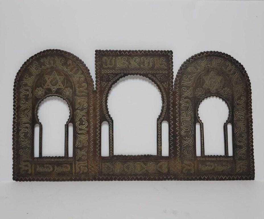 A scarce antique Moorish architectural model thin bronze plaque from the late 19th century.

This architectural model features a symmetrical design, the bronze frame having three sections, each panel with large traditional Moorish architecture