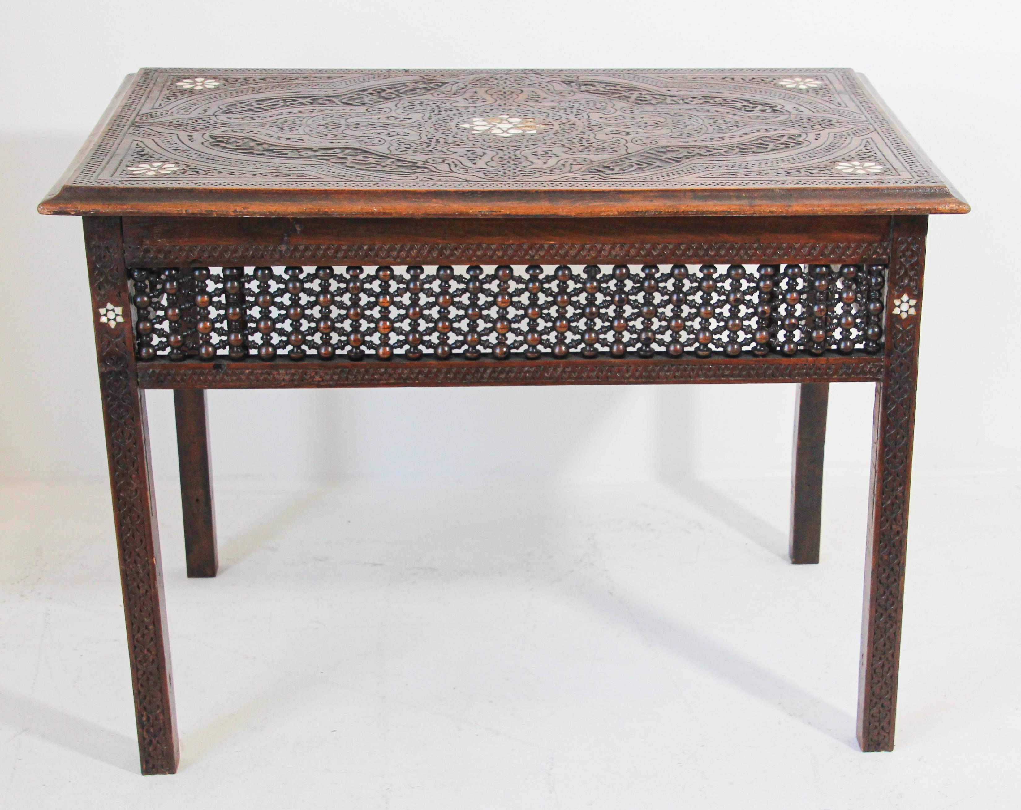 19th Century Moorish tea table inlaid with mother of pearl.
19th century Syrian style tea table, finely hand carved with foliages, arabesque design and Arabic writing, inlaid with mother of pearl in star Moorish designs, the sides are made of fine