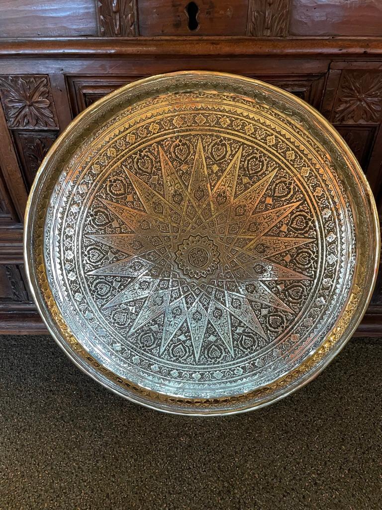 Top quality circa 1900 Moroccan brass tray etched with beautiful Moorish star and floral decoration. Clearly the work of a master craftsman. Heavy gauge brass. 
This is a wonderfully distinctive serving tray, or will make stunning top for a side