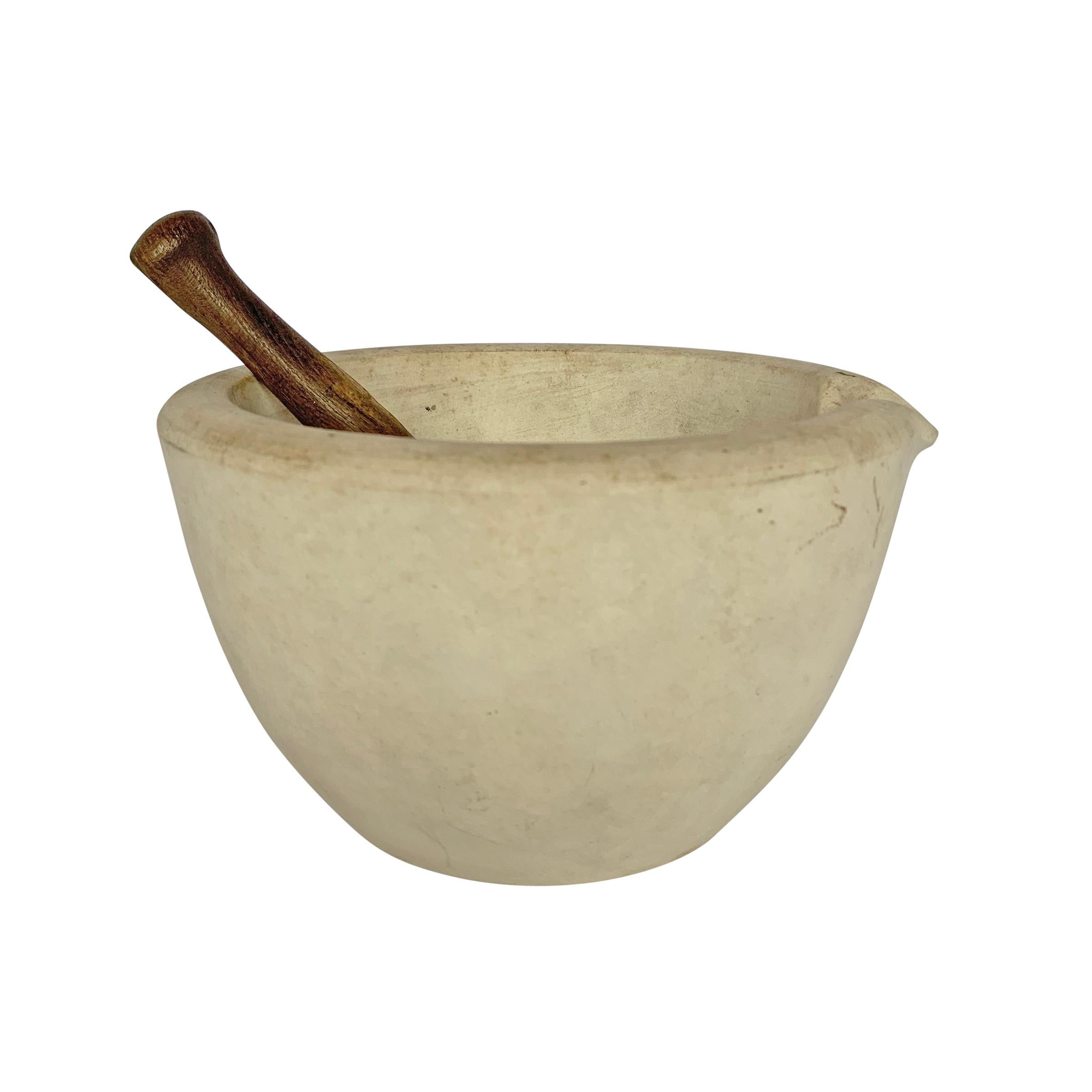 A 19th century American porcelain mortar and pestle from the Thomas Maddock & Sons, Trenton, NJ. The pestle has a wood handle with a smooth porcelain end. There are two marks on the bottom. One is the mark of the manufacturer, Thomas Maddock & Sons,