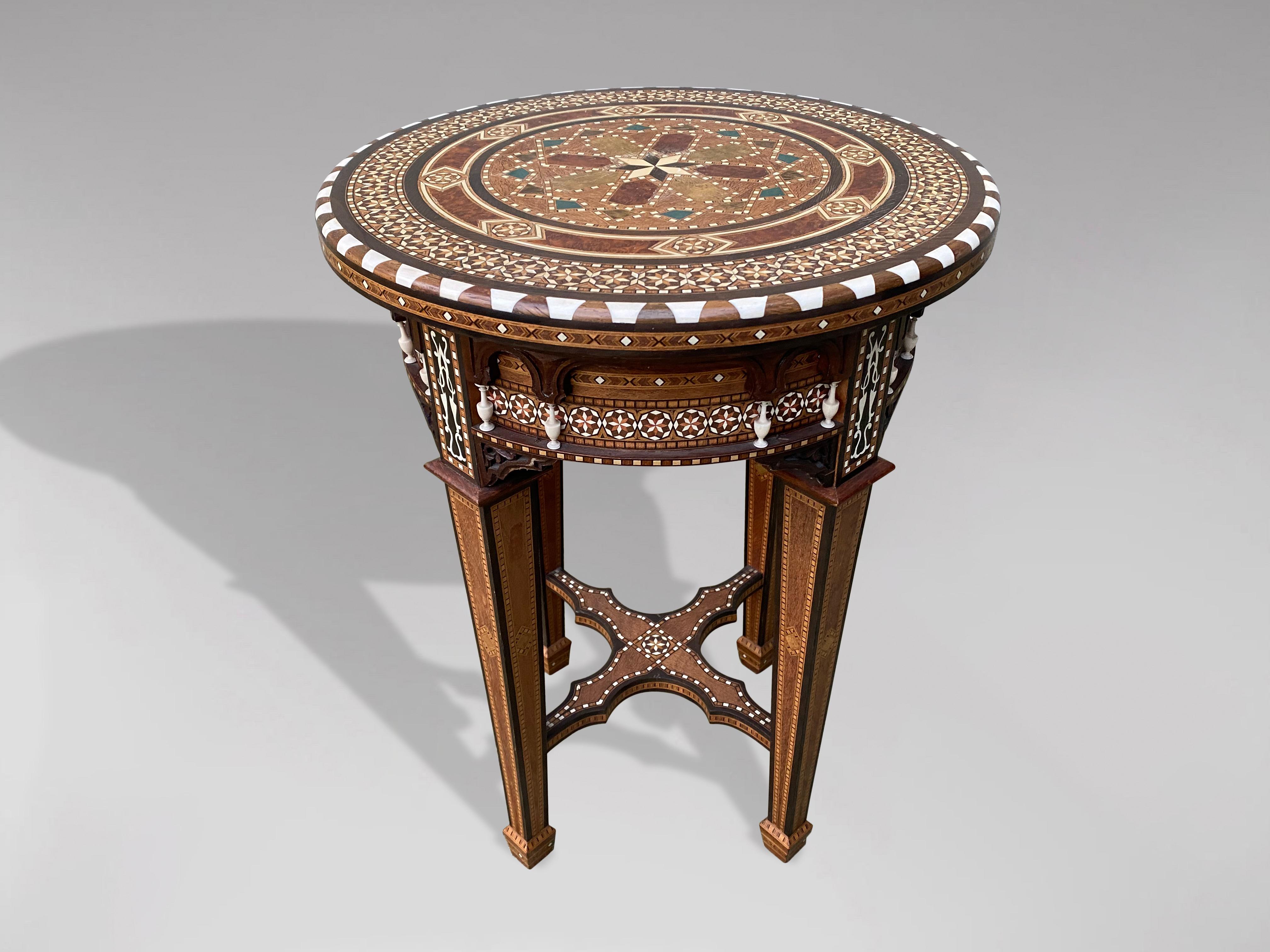 A fine late 19th century occasional table of circular form, inlaid with mosaic bone, ebony and other woods marquetry work throughout, having a shaped apron and raised upon square inlaid legs. This fine table is exquisitely handcrafted with beautiful