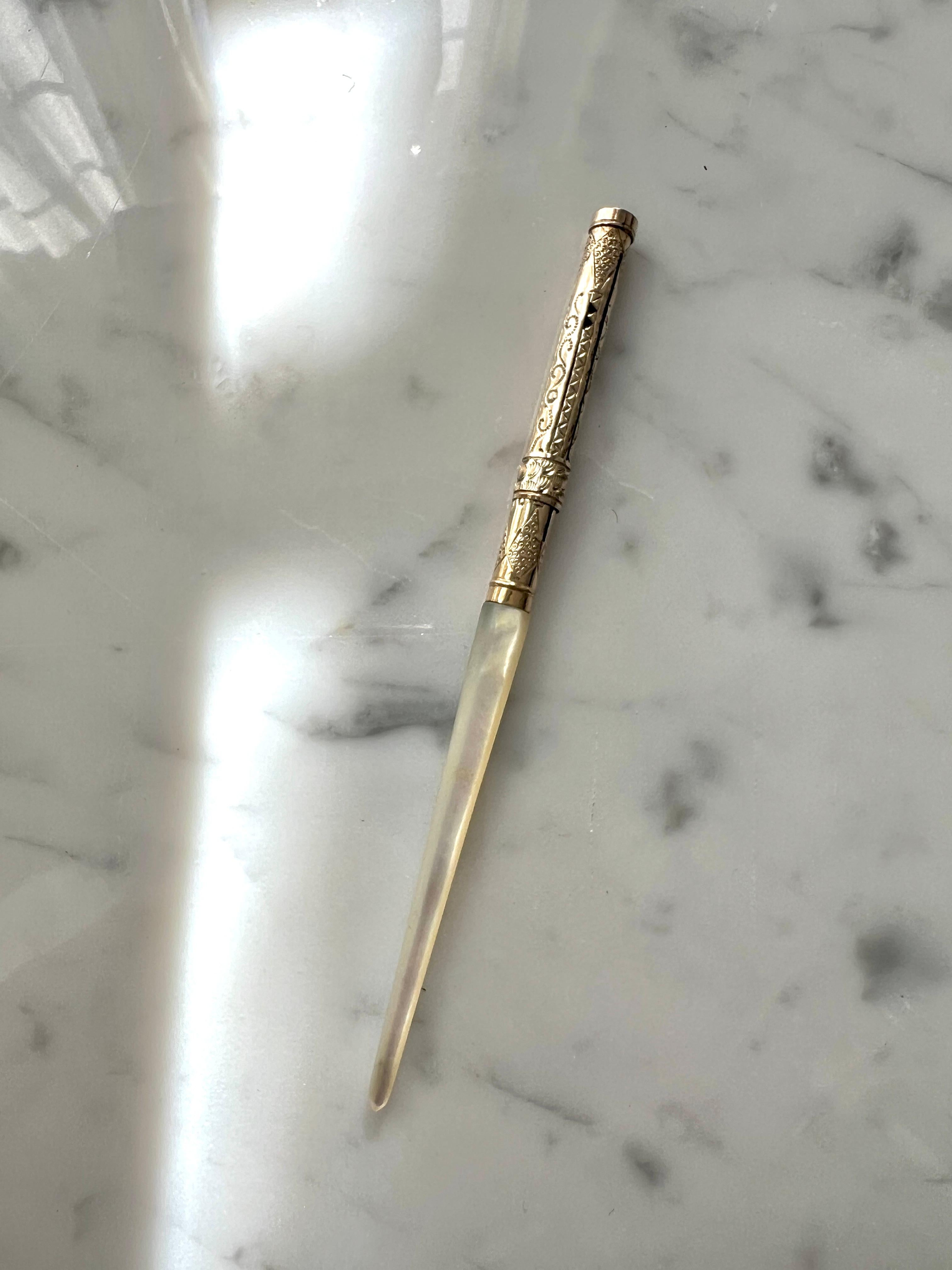 A beautiful vintage Fountain Pen - a lovely decorative piece for the desk, but also still fully functional.  The handle is Mother of Pearl that leads into an elegant Gold design and 14k eversharp tip. 

The tip is retractable - with the push of a