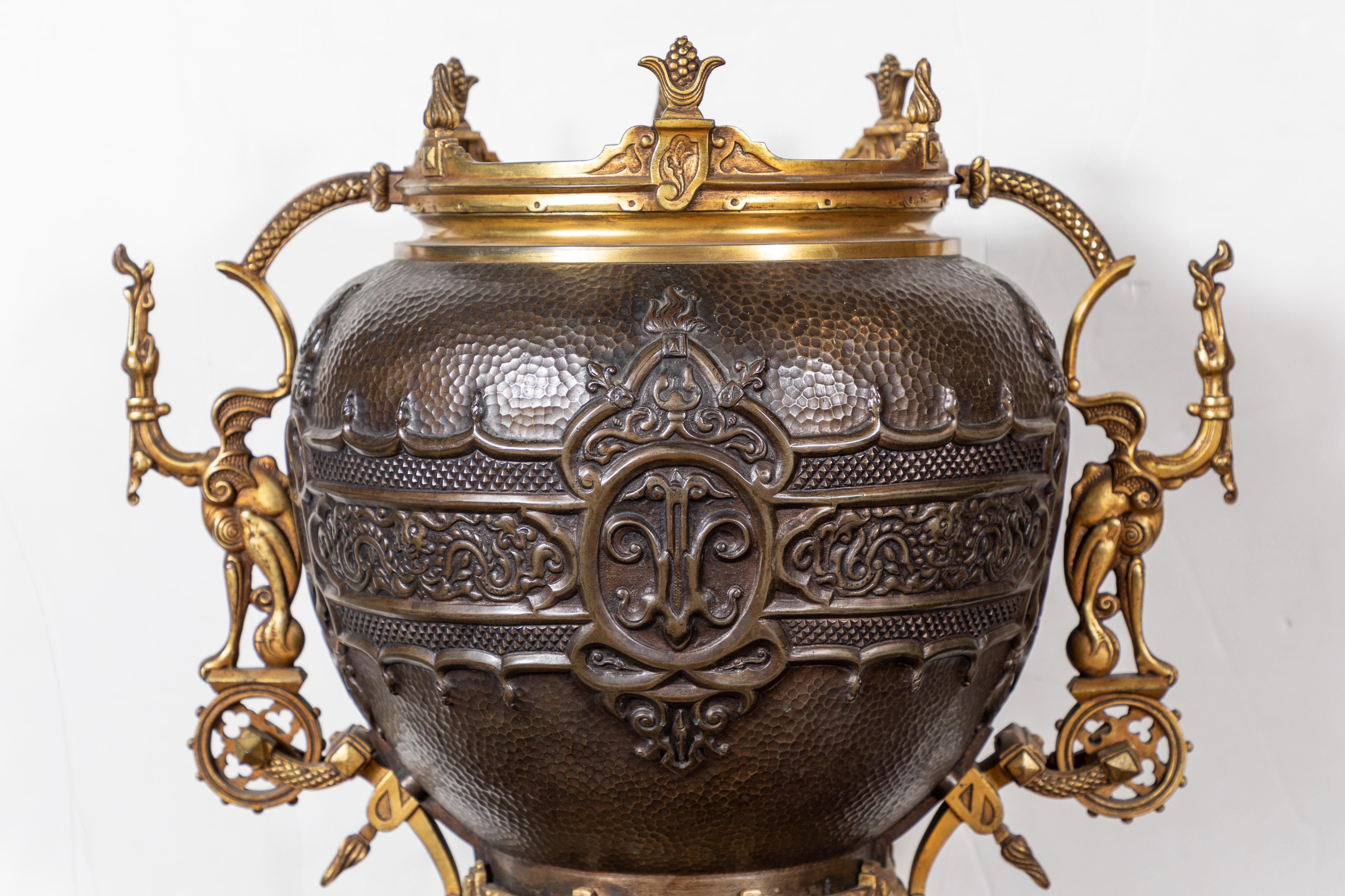 Remarkable, large, solid bronze and gilt bronze French planter on a stand. The central vessel in beautiful repoussé featuring a band of dragon forms. The entirety of the gilt bronze Stand featuring an elaborate array of finials, pierced handles and