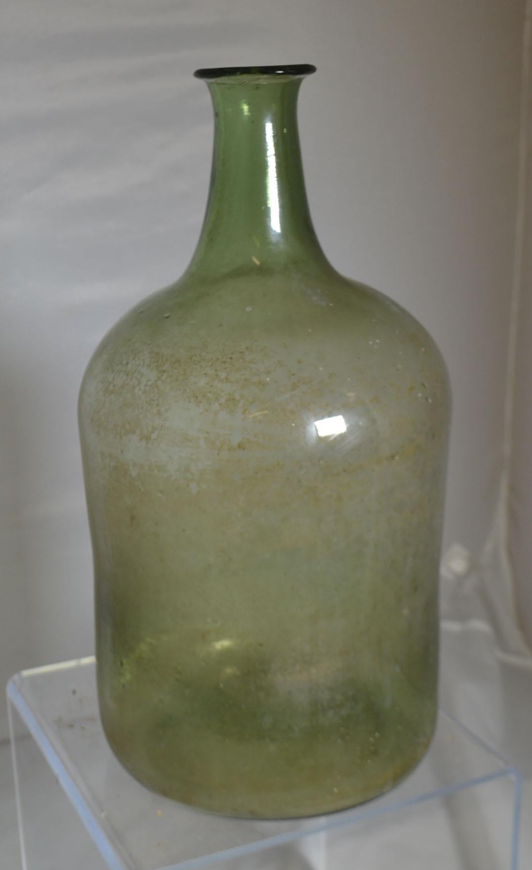 19th century mouth blown wine bottle with basket, circa 1860.