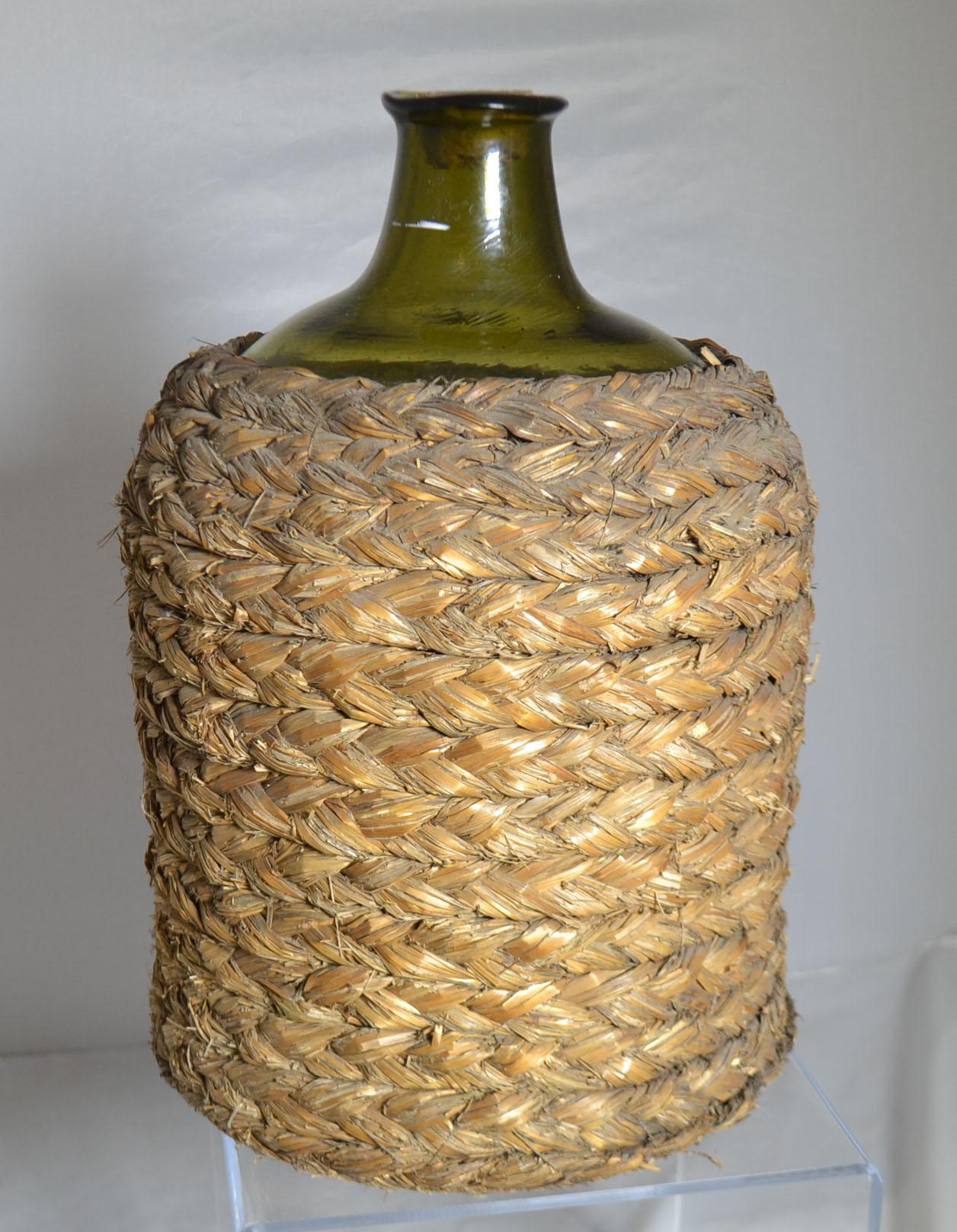Mouth blown wine bottle with basket, circa 1860.