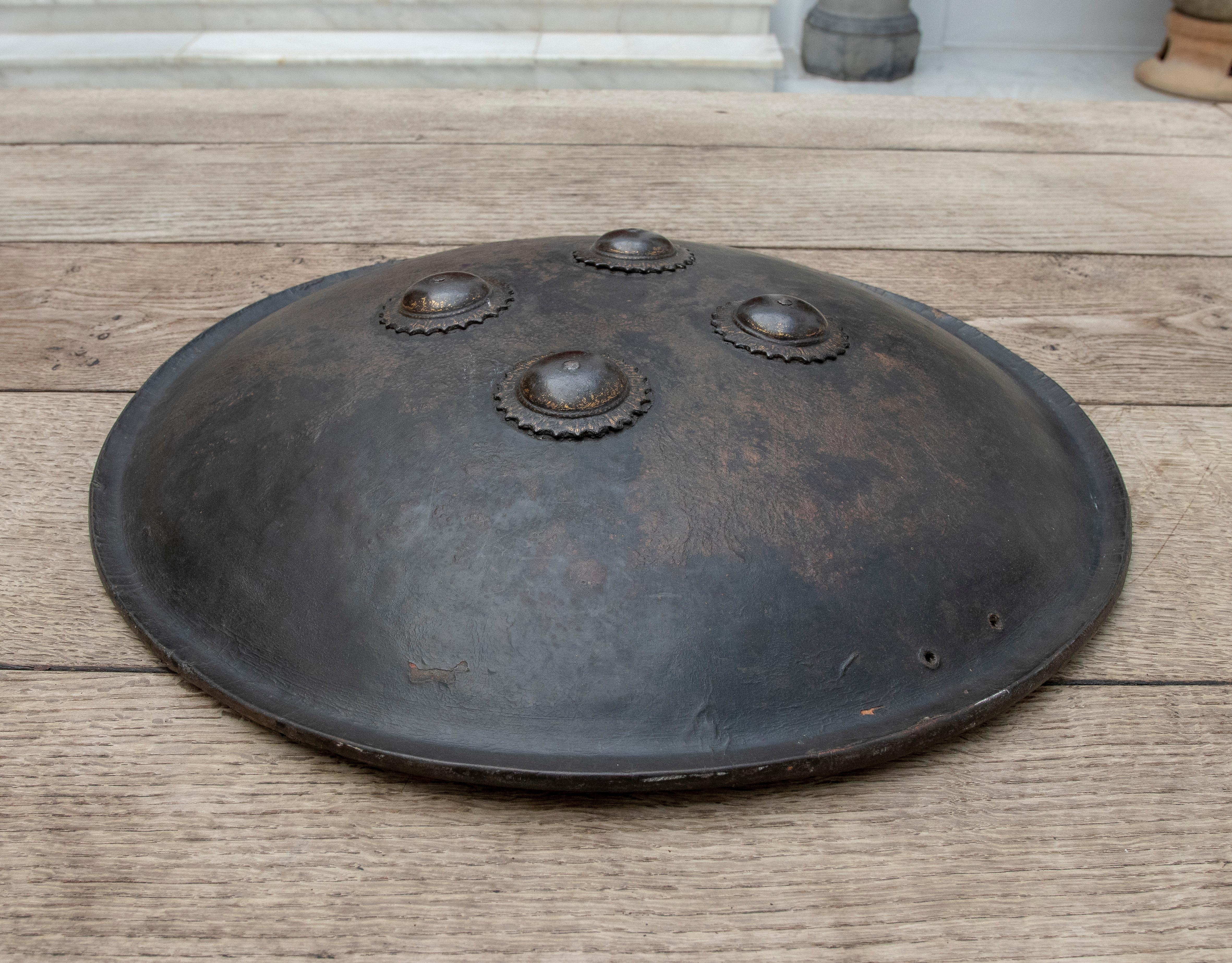 19th Century Mughal leather shield and bronze finials with traces of gold.