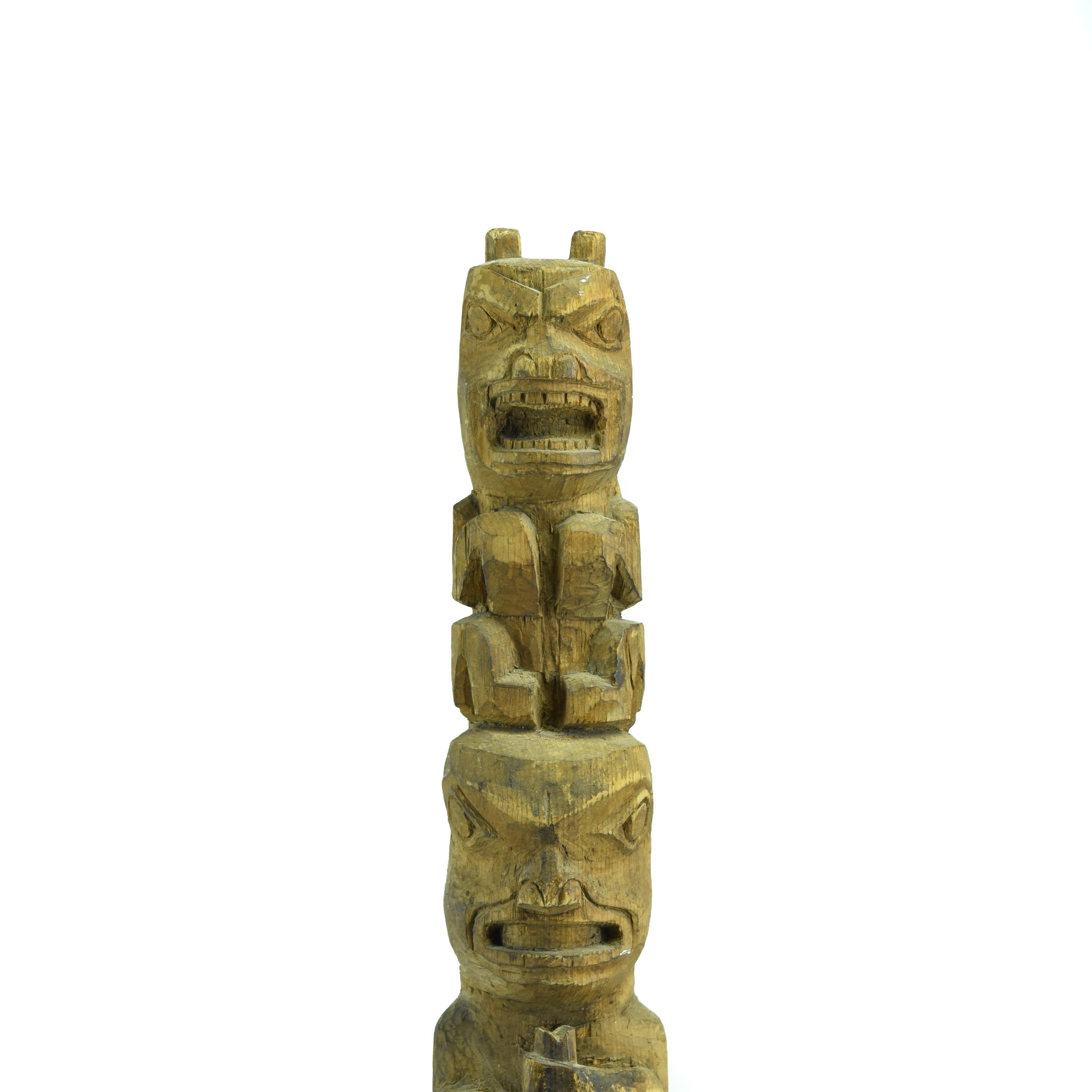 Complex Multifigure Tlingit Totem Pole from Sitka, Alaska. This larger red cedar model totem pole was carved by a Tlingit artist from Sitka, Alaska. The pole is unusually complex for a Tlingit pole and features seven interlocking figures. The pole