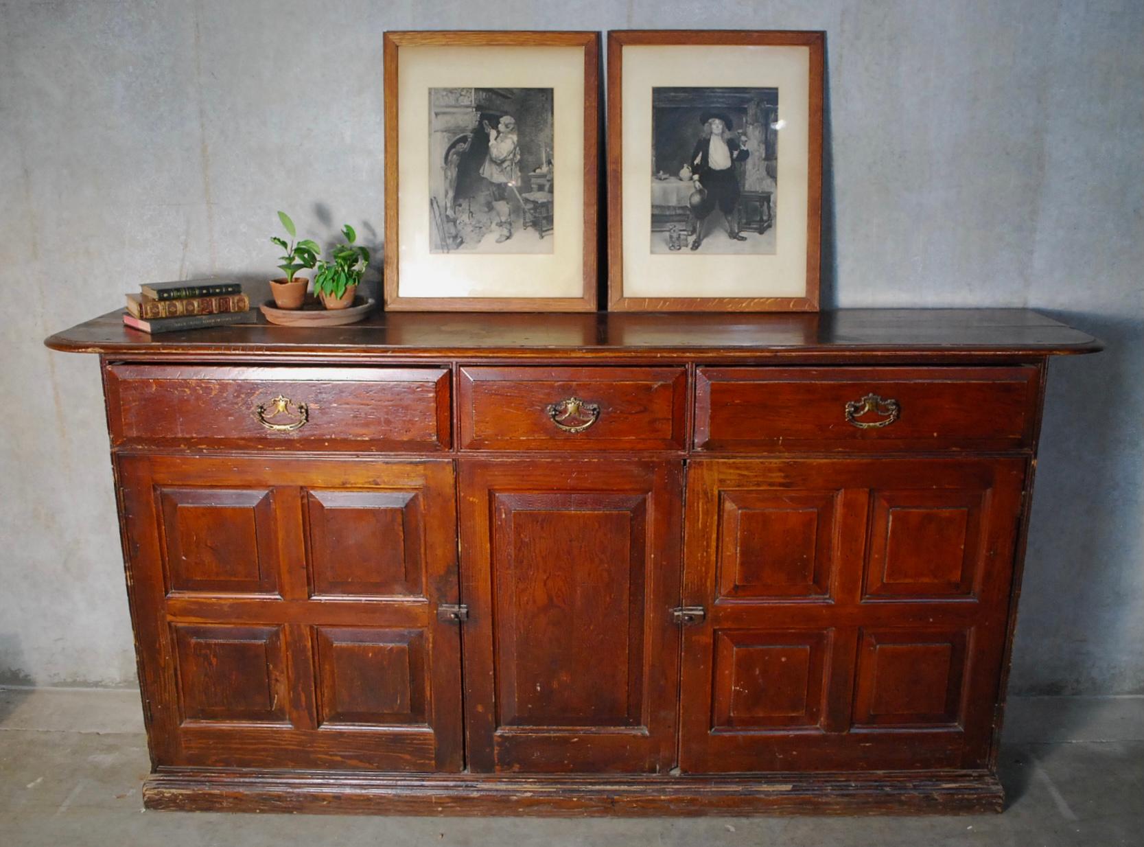 Very nice multi panel oversized sideboard acquired from a manor house in Central Canada. This piece is in untouched as found natural condition showing original age cracked surface finish.
Very nice configuration with functioning doors and