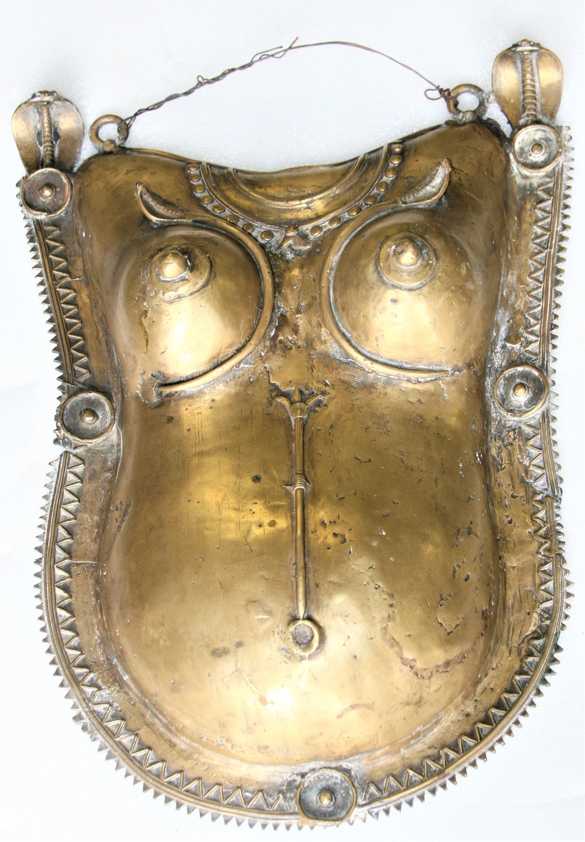 To day such delicate bronze body masks so ornately made, can be found only in museums. View the ornately made mask with stylized cobras on the shoulders. The mask after it was cast was hand chiseled to perfection. The two snakes intertwined and end