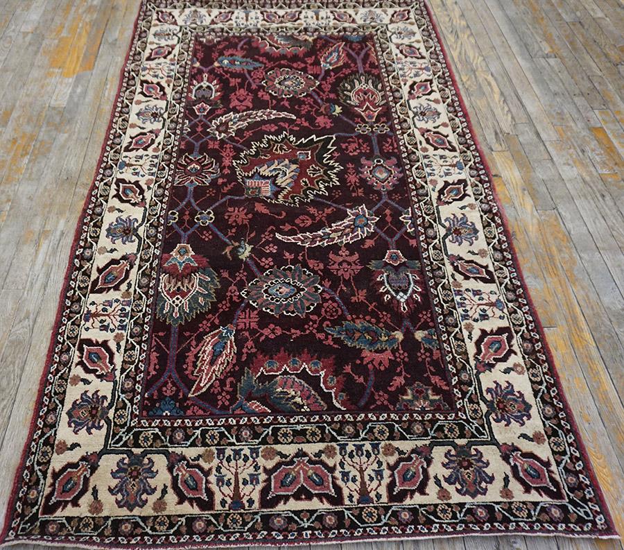 The pattern of this c.1880 antique rug from northern India is directly derived from the classical Indian Mughal Lahore carpets. The pattern, on the deepest colored ground imaginable, focuses on a giant, elaborate palmette, around which circle lancet