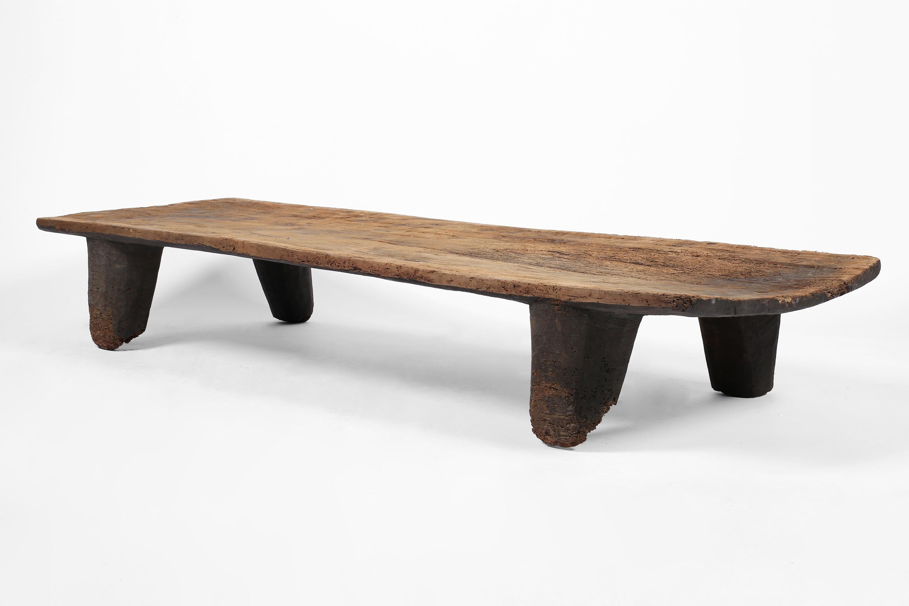 A monumental low coffee table, carved from a single piece of heavily patinated timber. This piece began life as a bed, originally used by a minority tribe in the small state of Nagaland, north-eastern India, near to the border with Myanmar, circa