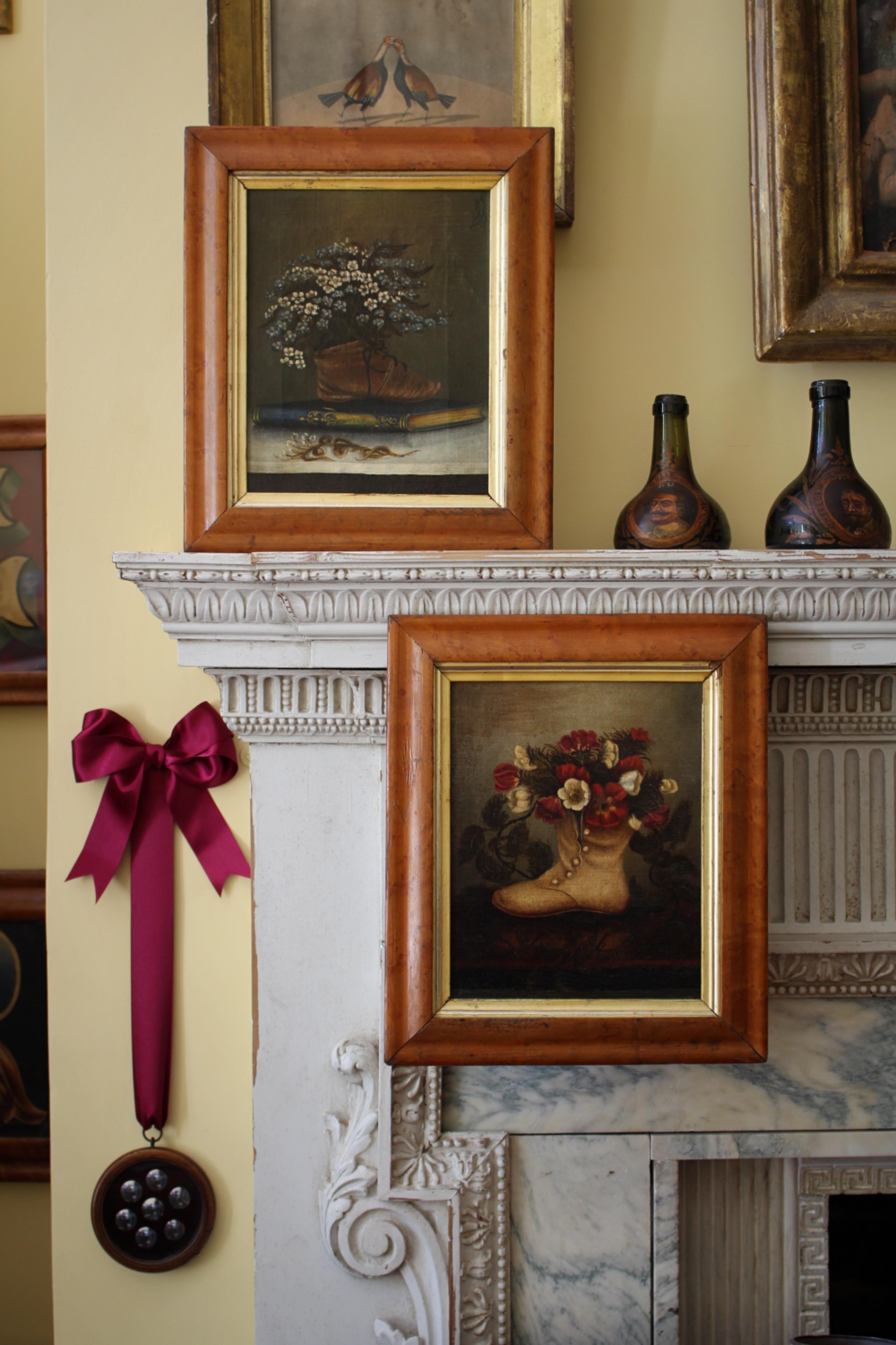 A delightful pair of floral still-life paintings, dating to the mid/second half of the 19th century. Oil on canvas and presented in period maple frames with gilt slips. Each painting depicts a shoe holding flowers, one is set upon a book with