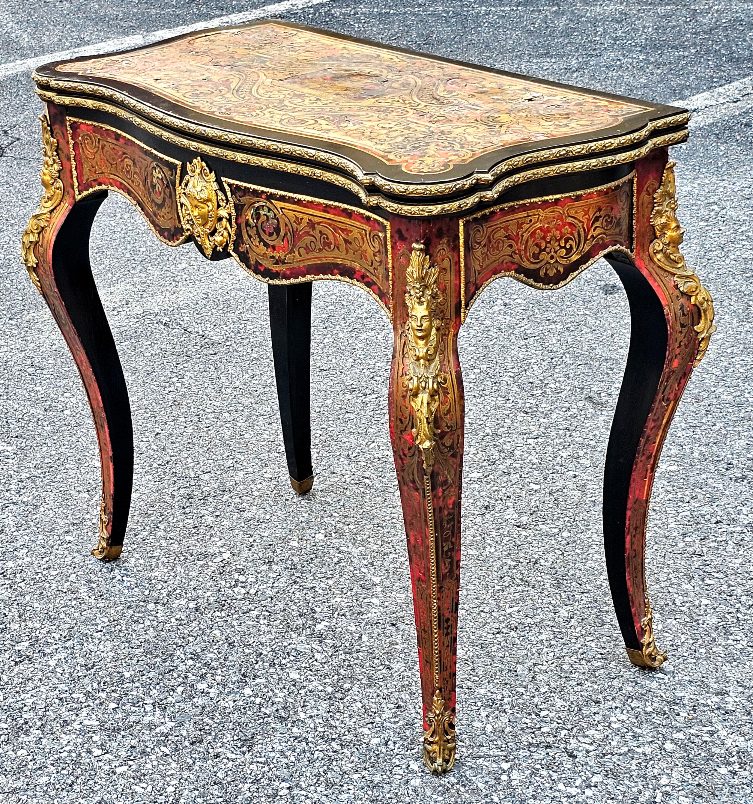 This 19th century serpentine front fold top console and games table captures the essence of André Charles Boulle’s work perfectly; with classical designs in brass inlay to the top,  front , sides back and the exhibition quality espagnolette