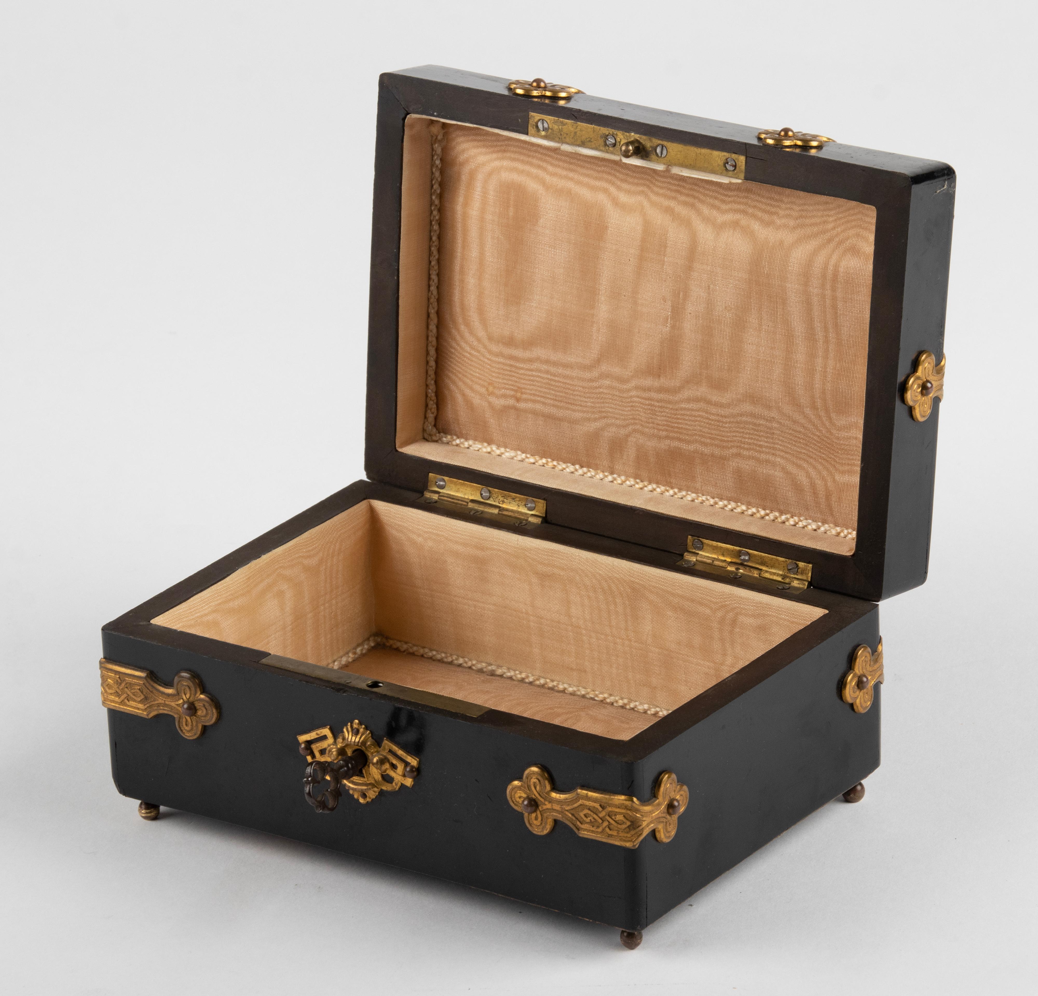 Antique decorative wooden box. Beautifully decorated with copper and bronze elements and round cut stones (tiger eye). The box is made of black lacquered wood (pine). The interior is upholstered in a light silk fabric, original from the time. The