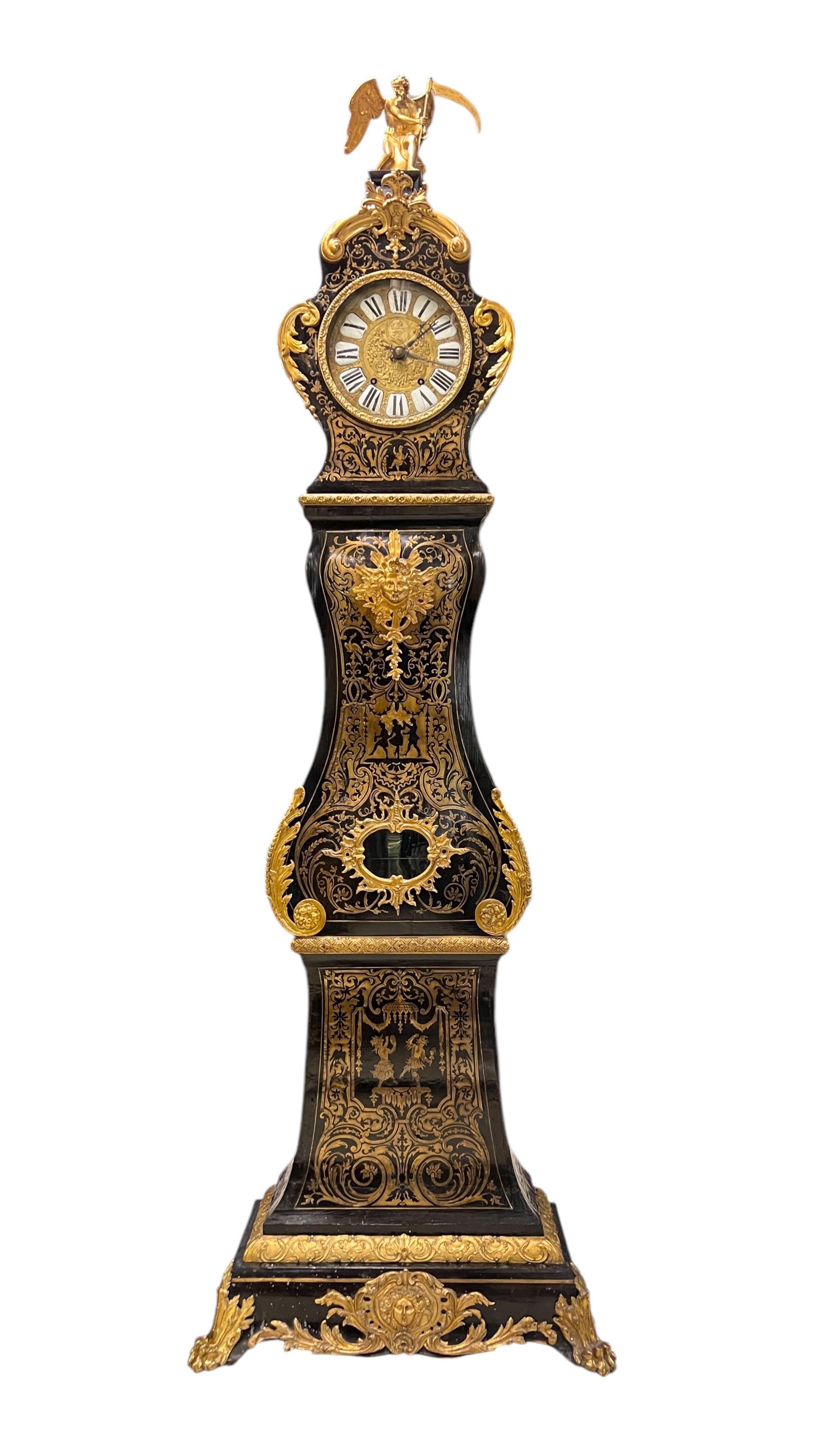 Antique (19th century) longcase clock in the manner of André Charles Boulle (1642-1732) measuring 90 by 30 by 13 inches, with ebonized finish decorated with exceptional inlaid brass, with gilt bronze mounts including mask, foliate scrolls and