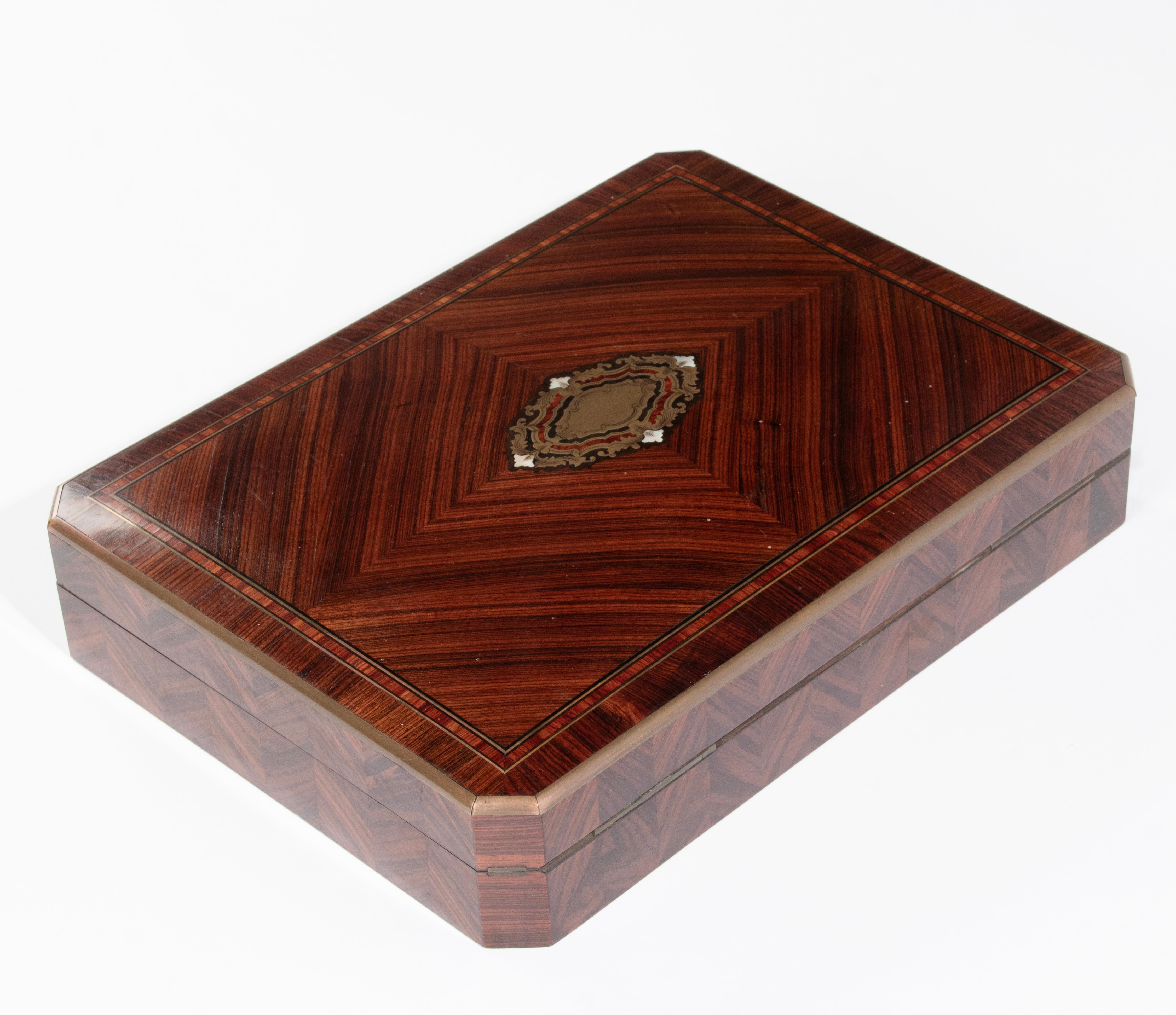 Beautiful antique game box from the French Napoleon III period. The box is made of book veneer match, inlaid with brass trims. This box shows the fine craftsmanship of the ebenist who made the box. The interior has compartments for chips and cards.