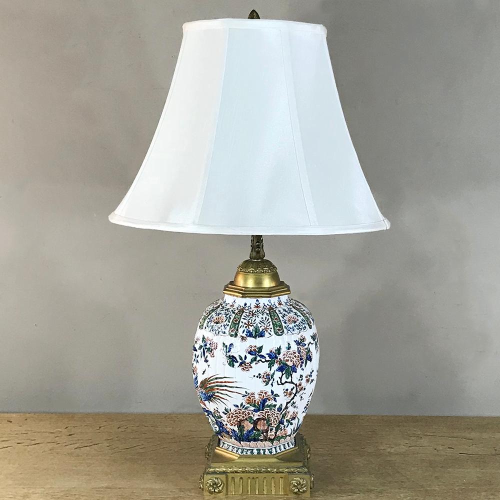 19th Century French Napoleon III Hand Painted Faience and Bronze Oil Lamp has been converted into an electric table lamp. Crafted in France, circa 1880s, the hand painted porcelain 