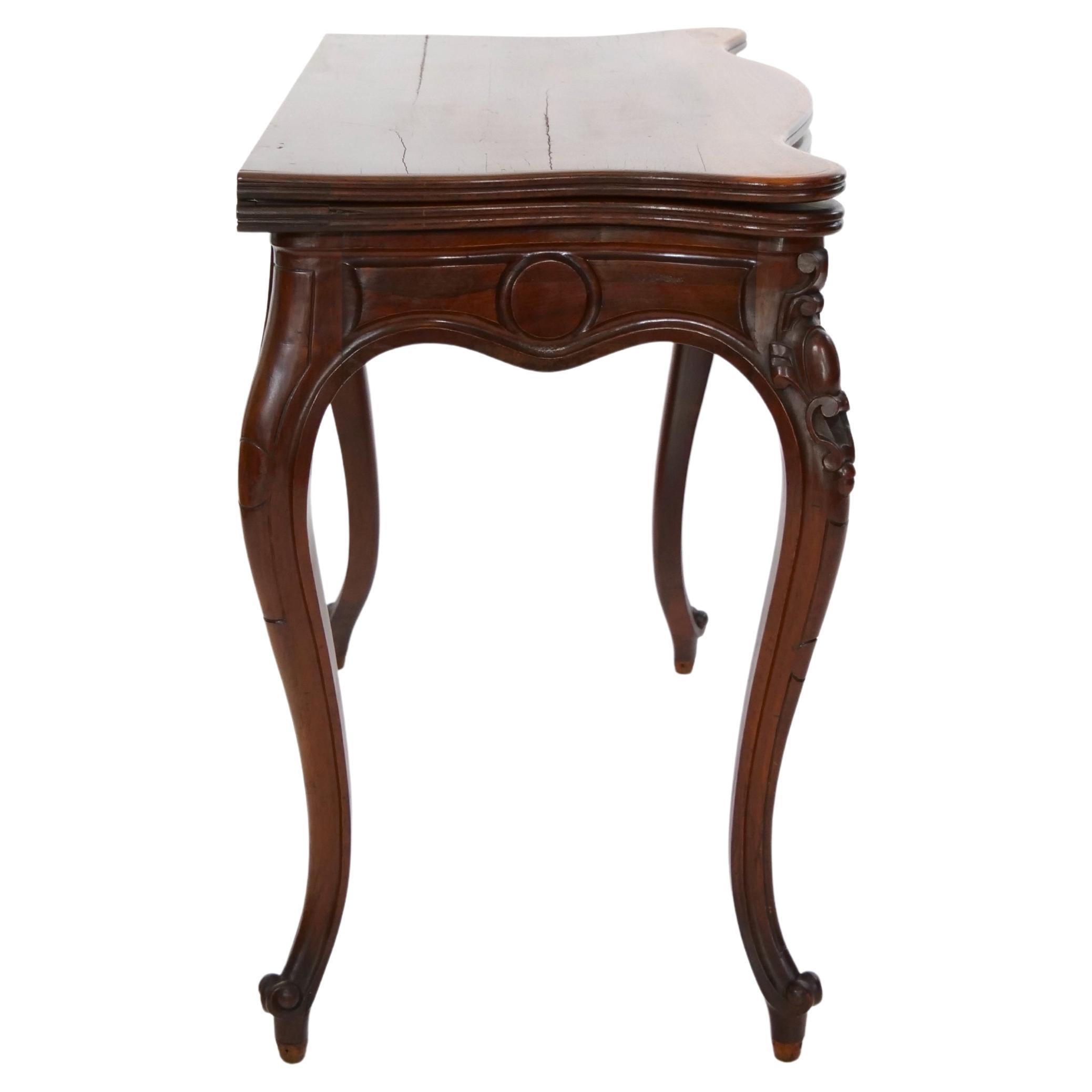 Early 19th Century mahogany wood beautifully proportioned console or game table with a flip top leather details when open resting on a slightly curved cabriole legs. The table is in good antique condition.  Appropriate wear consistent with age /
