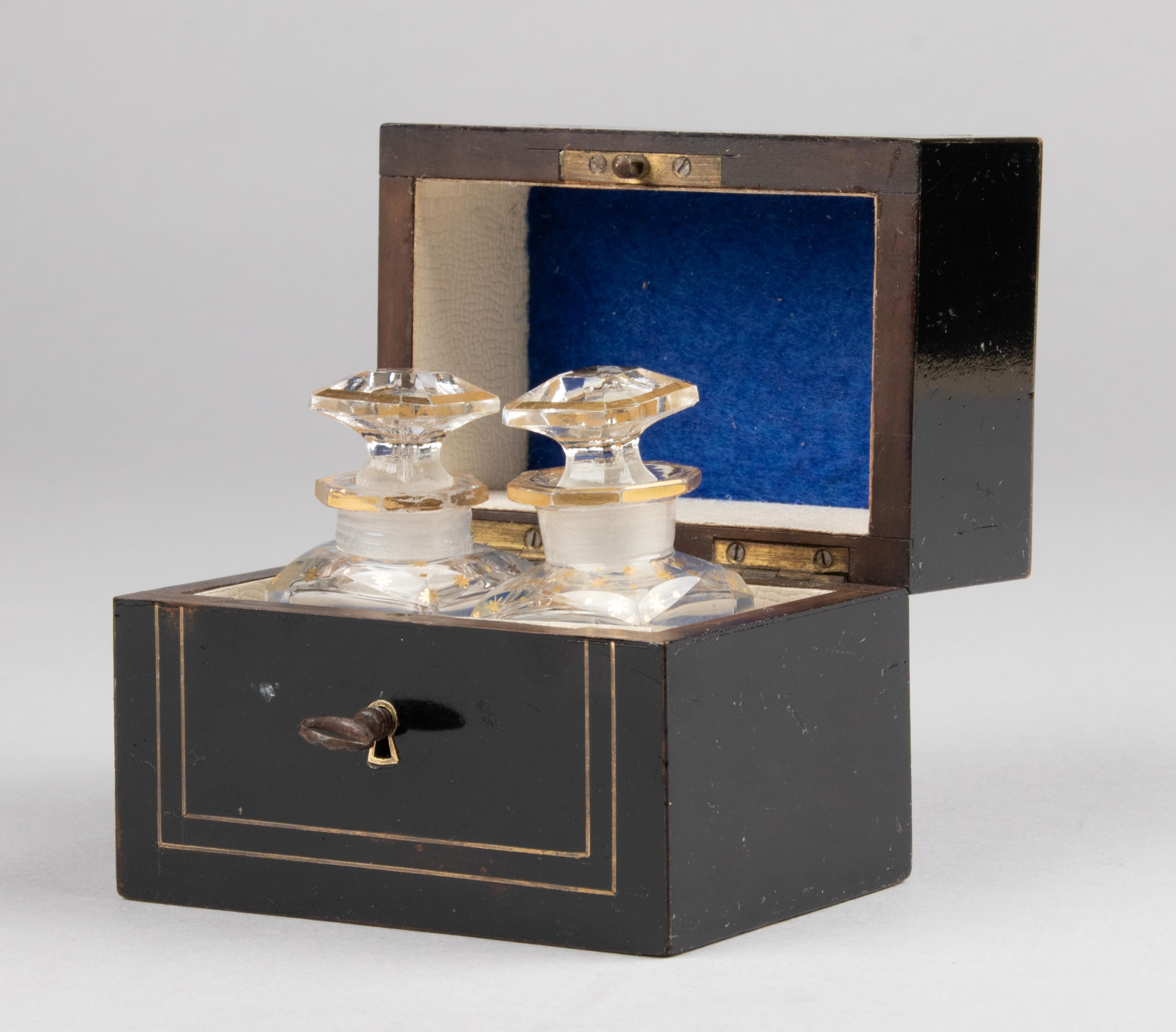 Lovely small antique wooden box with two original perfume bottles. This is quite a rare piece, the fact that it has the original crystal bottles makes it even more desirable. This box is French, from the Napoleon III period. Made of fine wood,