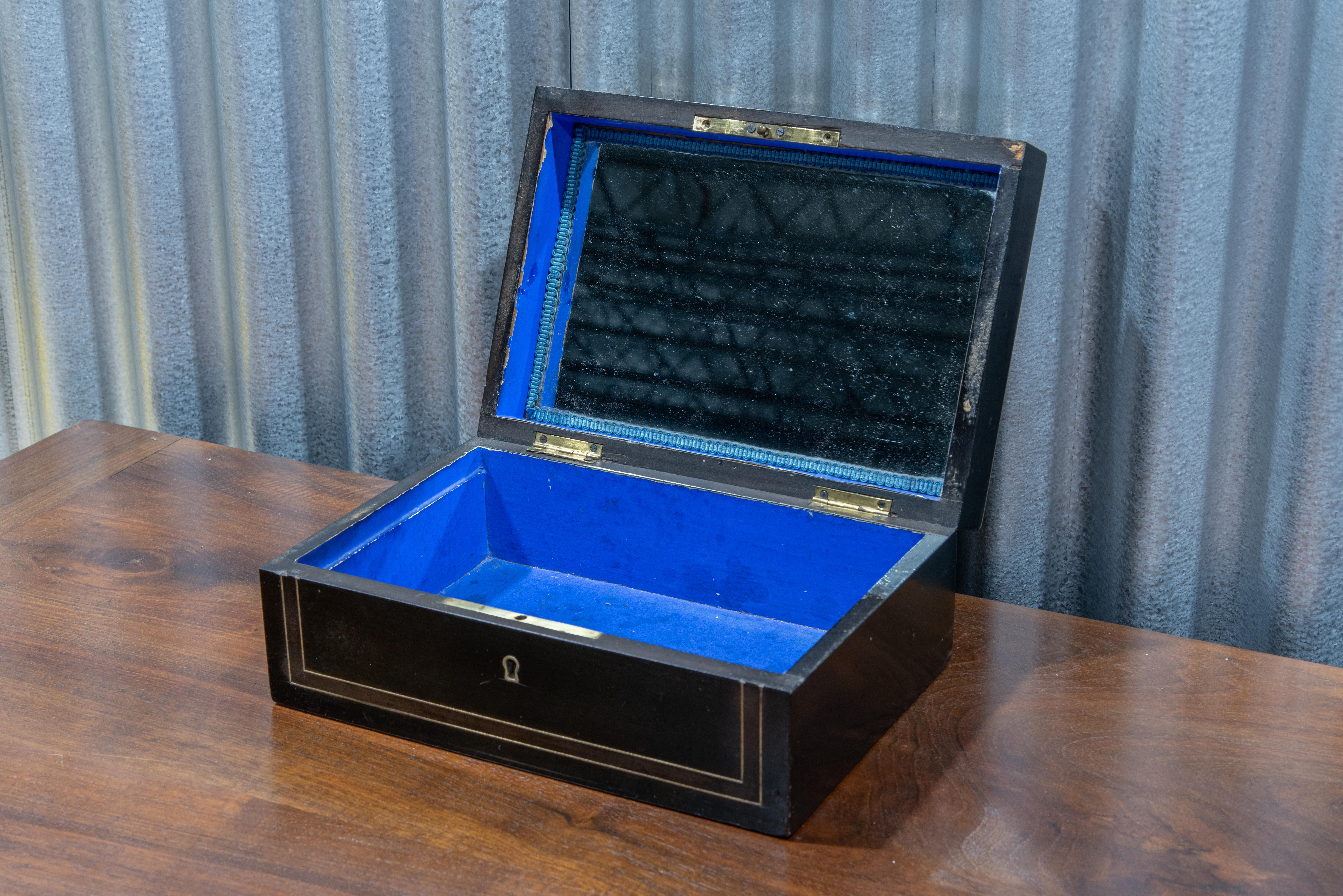 This 19th Century Napoleon III Period Jewelry Box is a true testament to the elegance and sophistication of its era. Crafted with meticulous attention to detail, the box features the hallmark attributes of Napoleon III design, including ornate