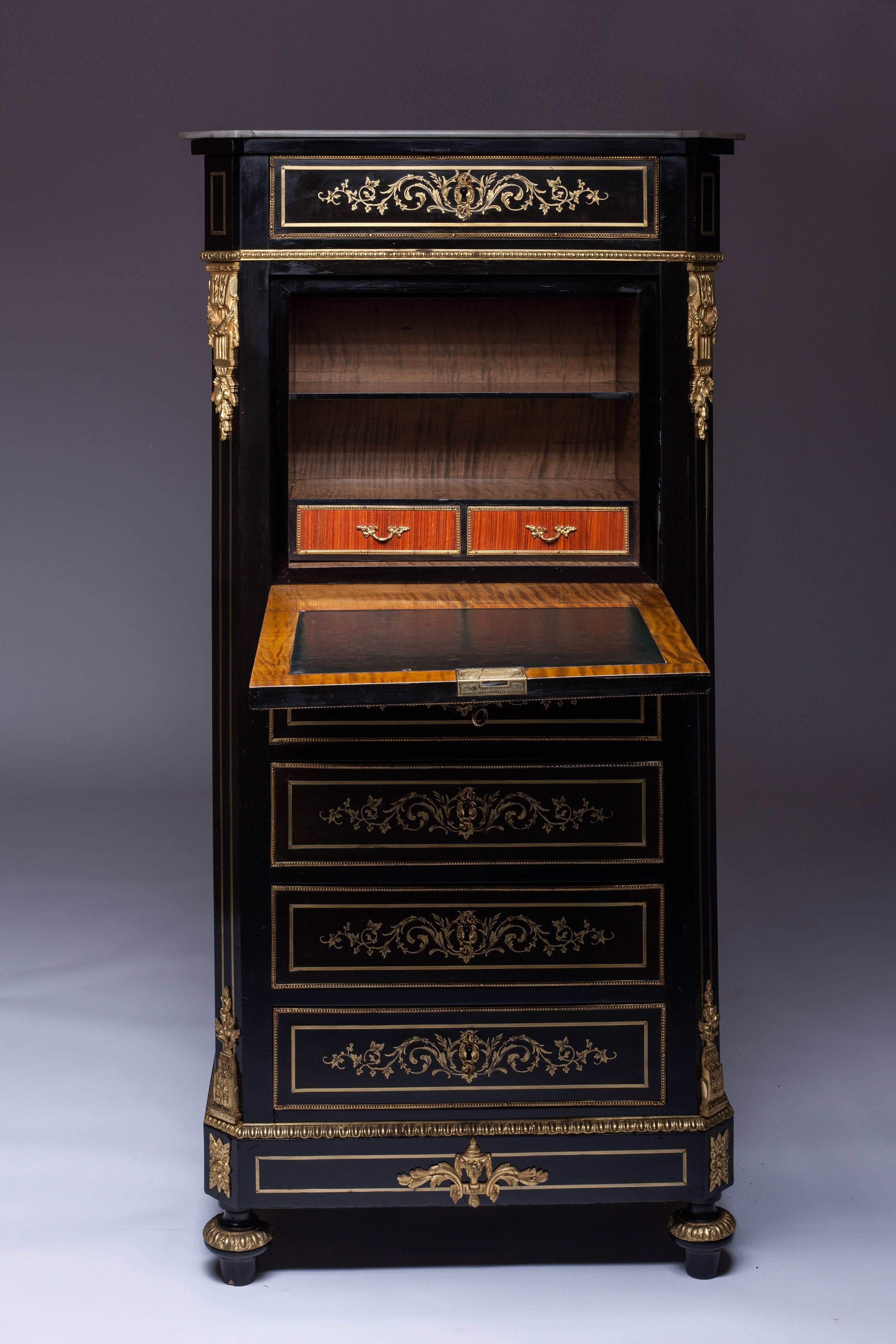 Ebonized wood secretary desk with brass, bronze marquetry of central decoration with flowered vases, fowl and scrollwork. Fitted with fall-front revealing two niches and one drawer and five drawers. Atop toupie feet.
Gilt bronze ornamentation.