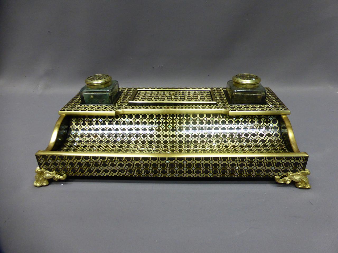 19th century Napoleon III style inkwell. Blackened wood, brass marquetry and mother of pearl accompanied by two glass inkcases closed by bronze cabochons.