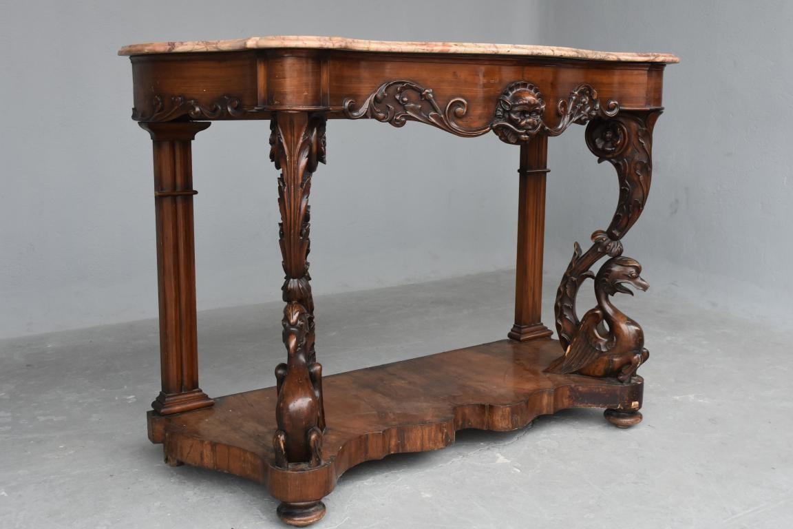 Superb and large 19th century Napoleon III console in mahogany veneer richly carved with bird’s decoration. Note that the tip of a bird's beak is missing but will be replaced by our workshop. Some losses of veneers. Superb rose marble top enhanced