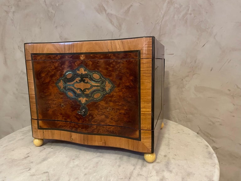 Very nice Napoleon III liquor cellar made with walnut veneer and beautiful brass marquetry on the top. 
Carafe and glasses made with Saint Louis Crystal and in very good condition. 
We can see a split on the top but the cave is still in good