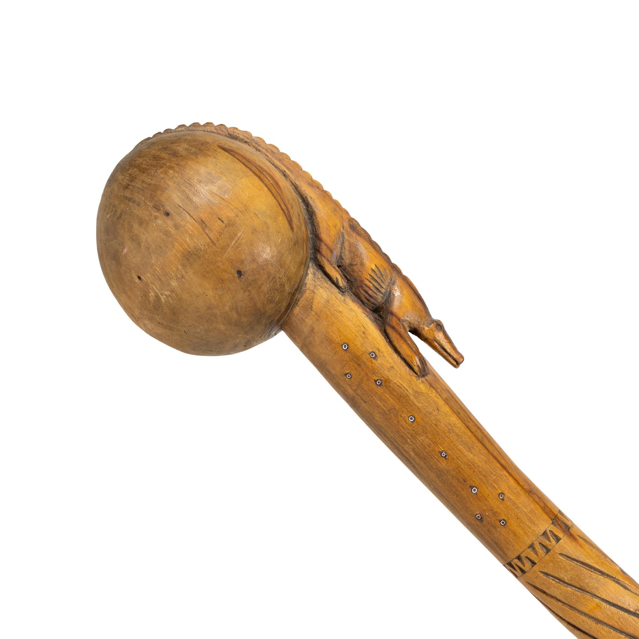19th century Native American Southeast headed ball club. With alligator effigy on handle and tail wrapping around the first half of the ball. Southern pine with handle both carved and inlaid with white-red heart beads. A beautiful piece for any
